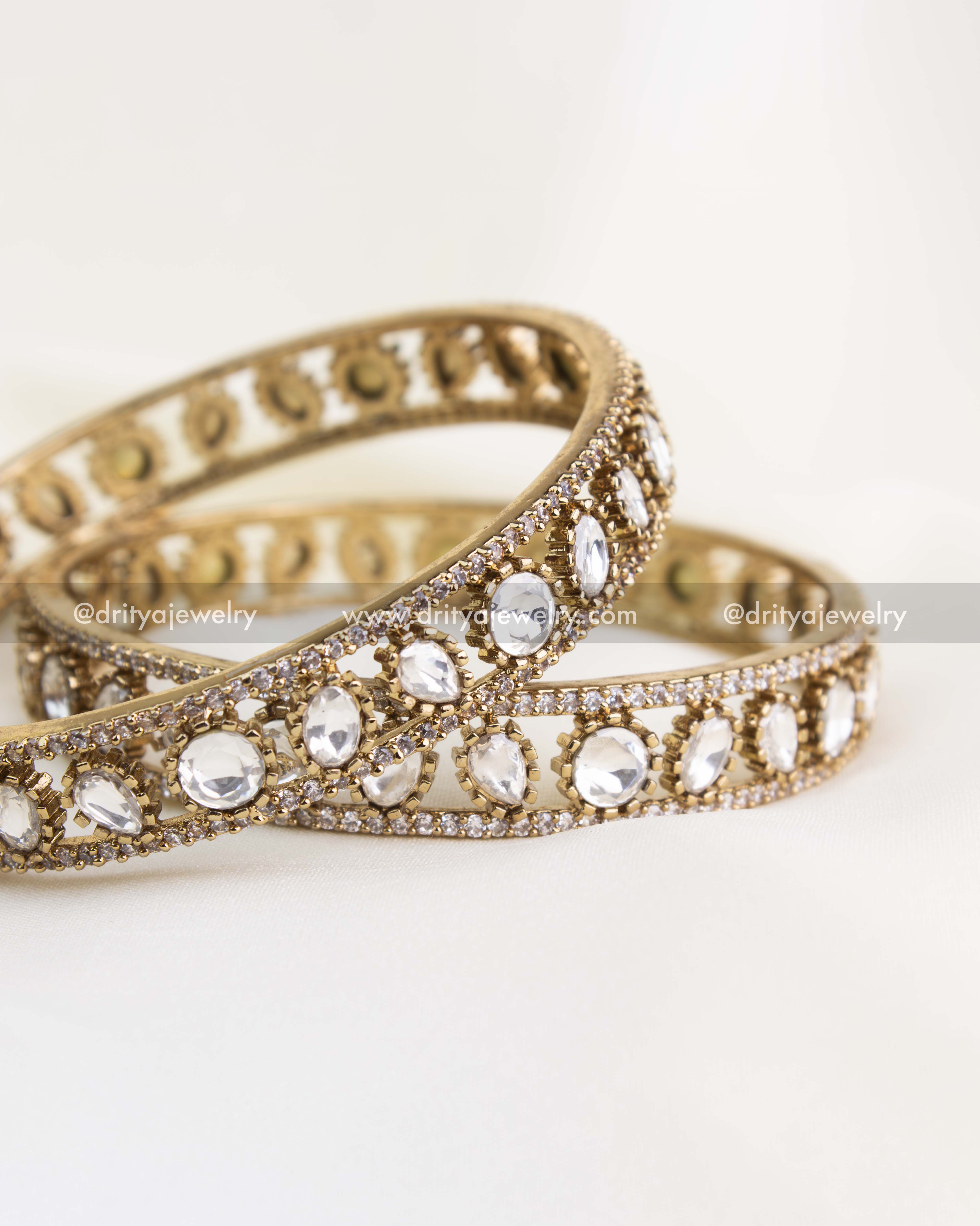 Close-up of handcrafted Kundan bangles featuring uncut-style stones and fine Victorian micro setting.