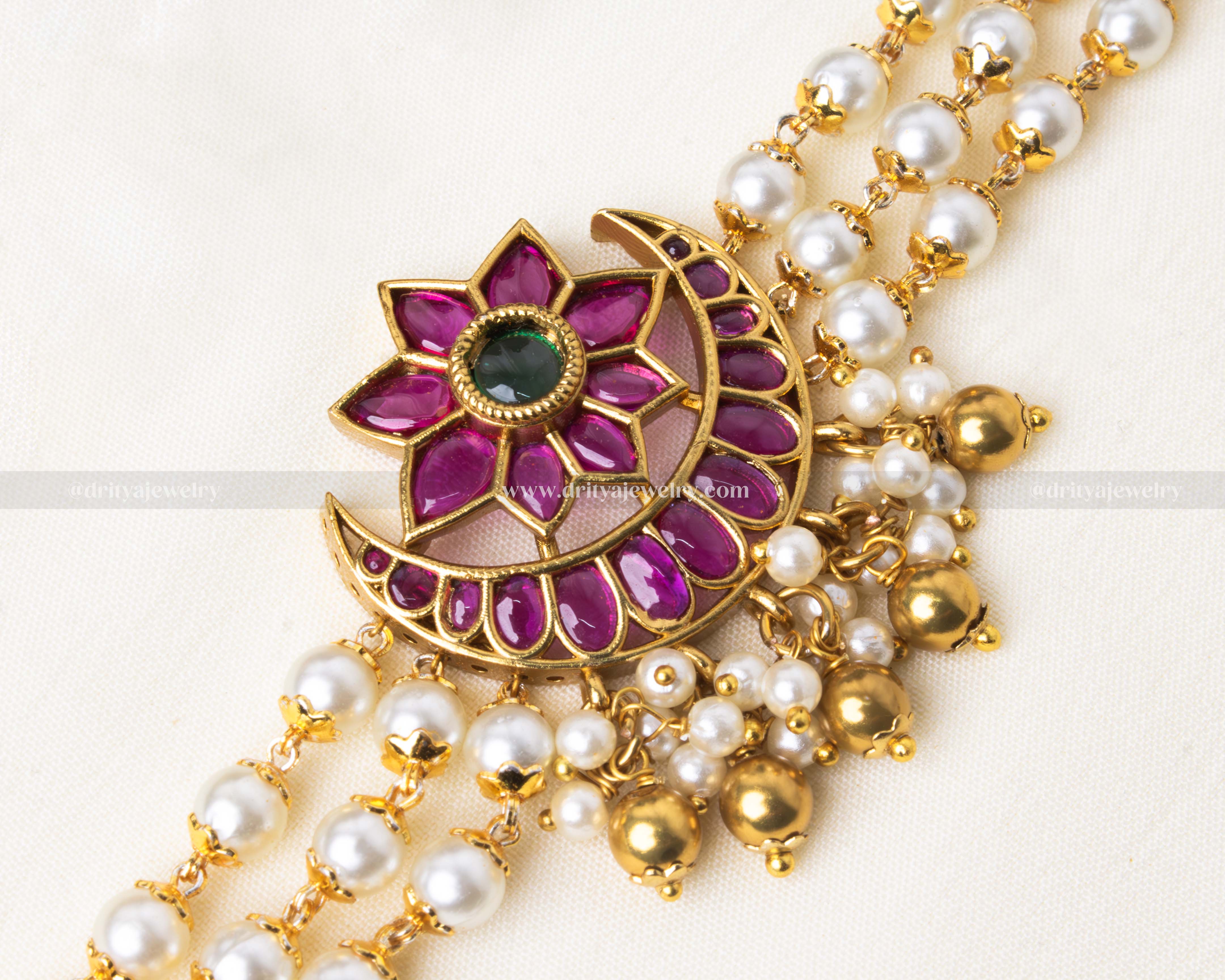 Intricate floral and crescent moon pendant design on the kemp jadua choker set.