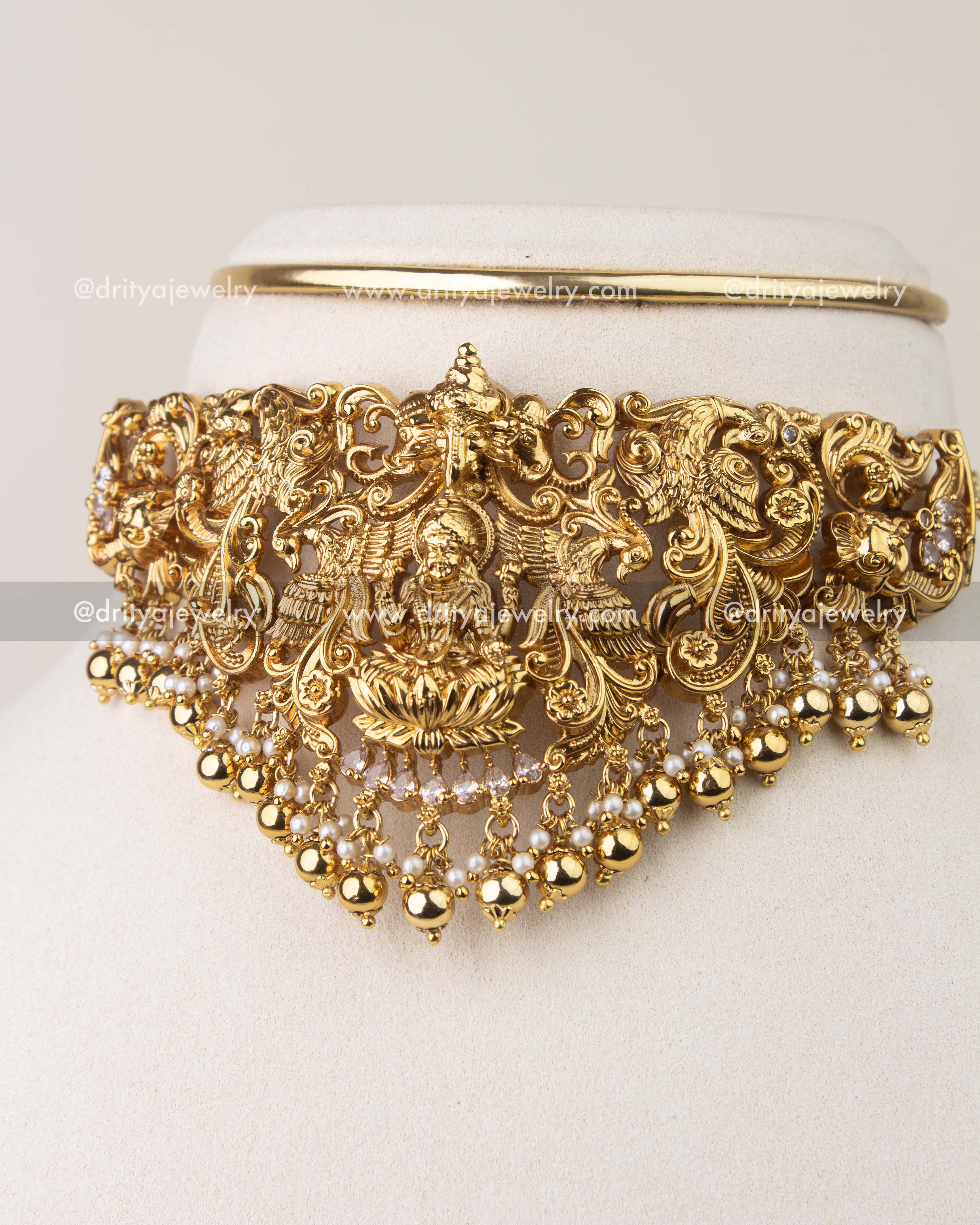 Close-up of Nakshi temple choker showing peacock carvings and pearl hangings