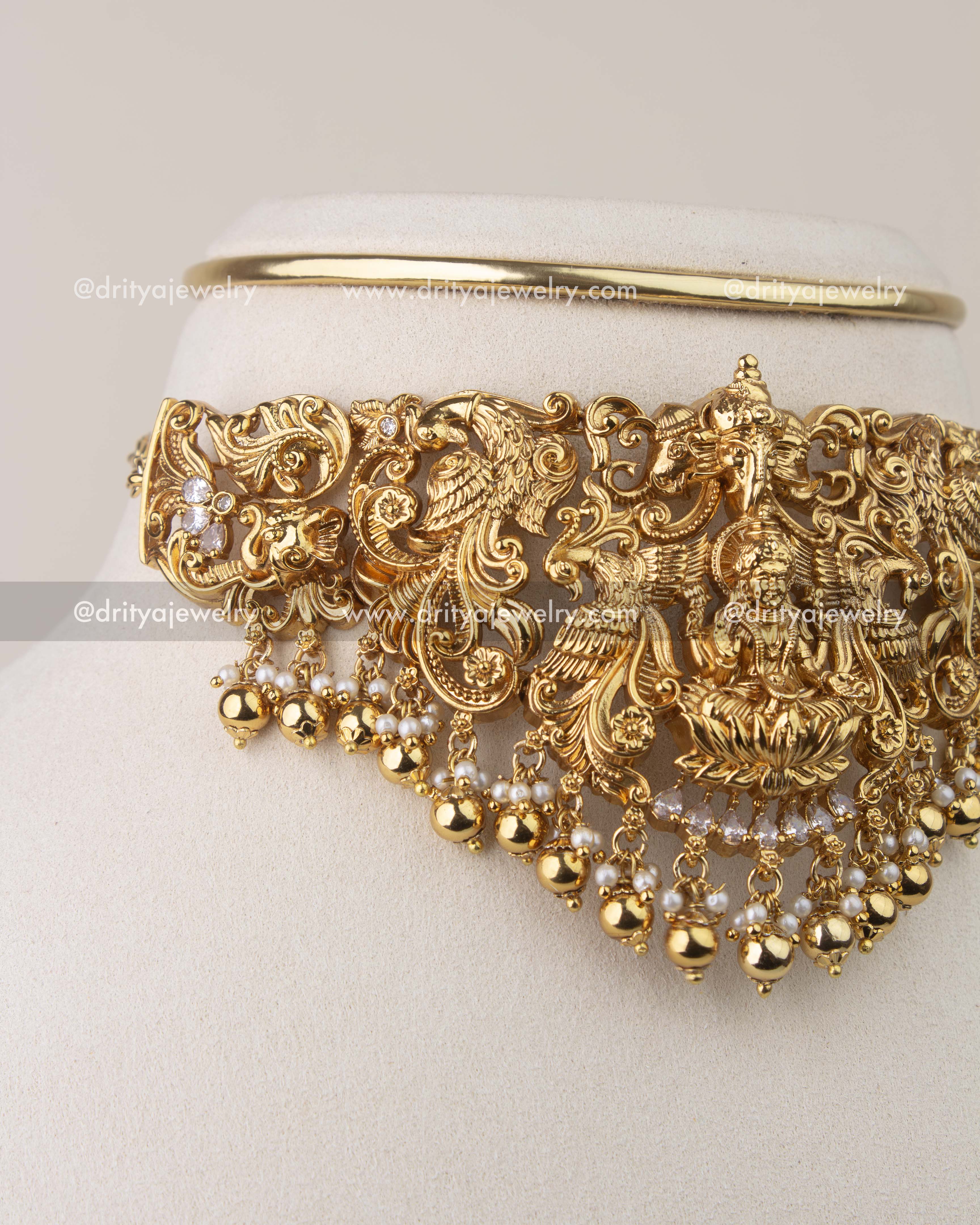 Close-up of Nakshi temple choker showing peacock carvings and pearl hangings