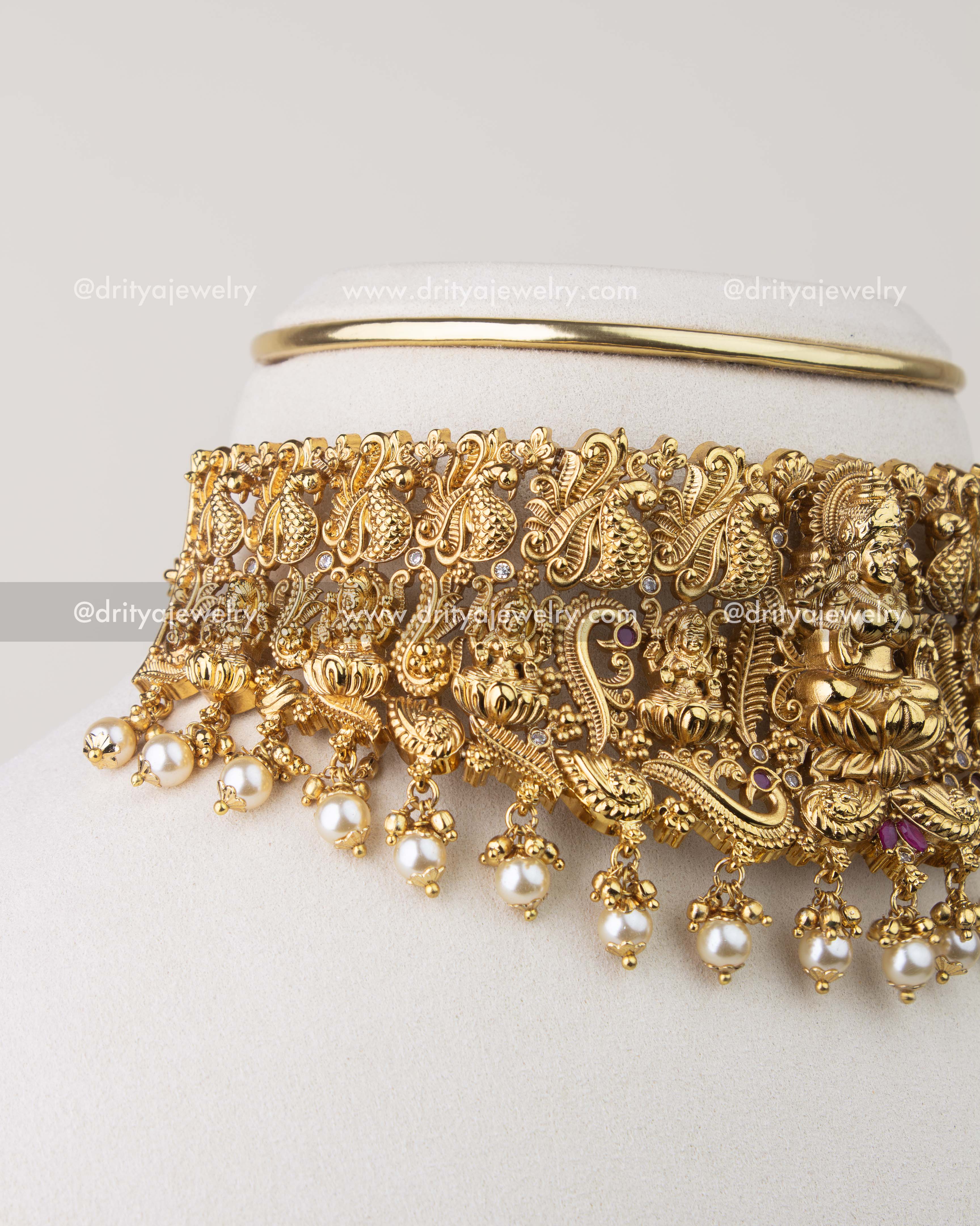 Close-up of Nakshi temple choker showing peacock motifs and pearl hangings