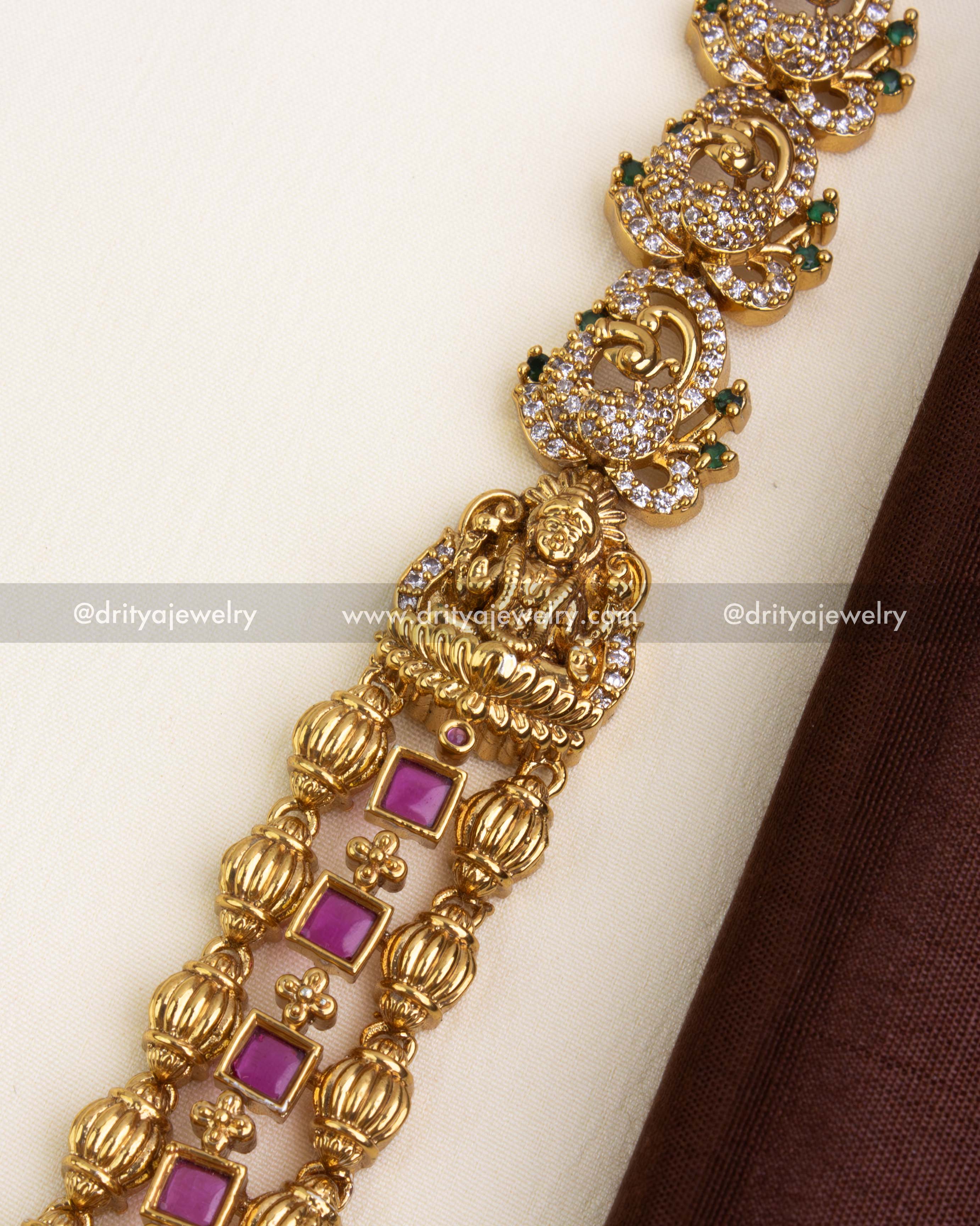 Detailed view of the handcrafted nakshi chain with ruby square accents.
