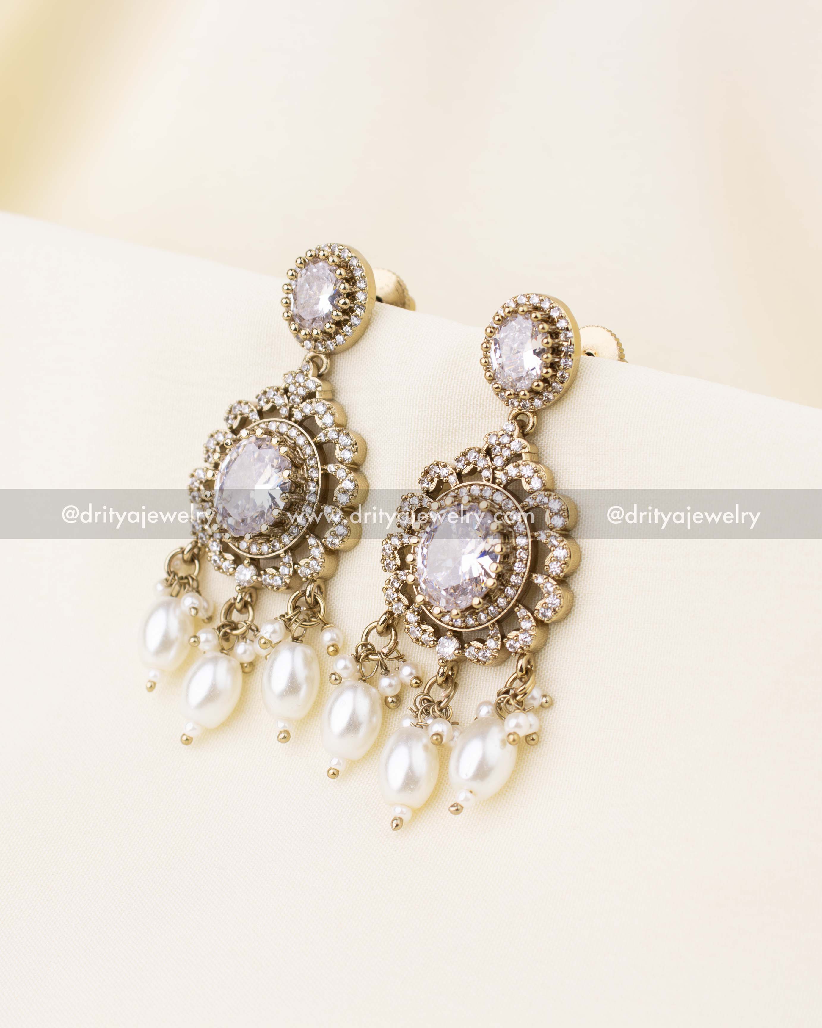 Elegant earrings with clear stones and pearl tassels.