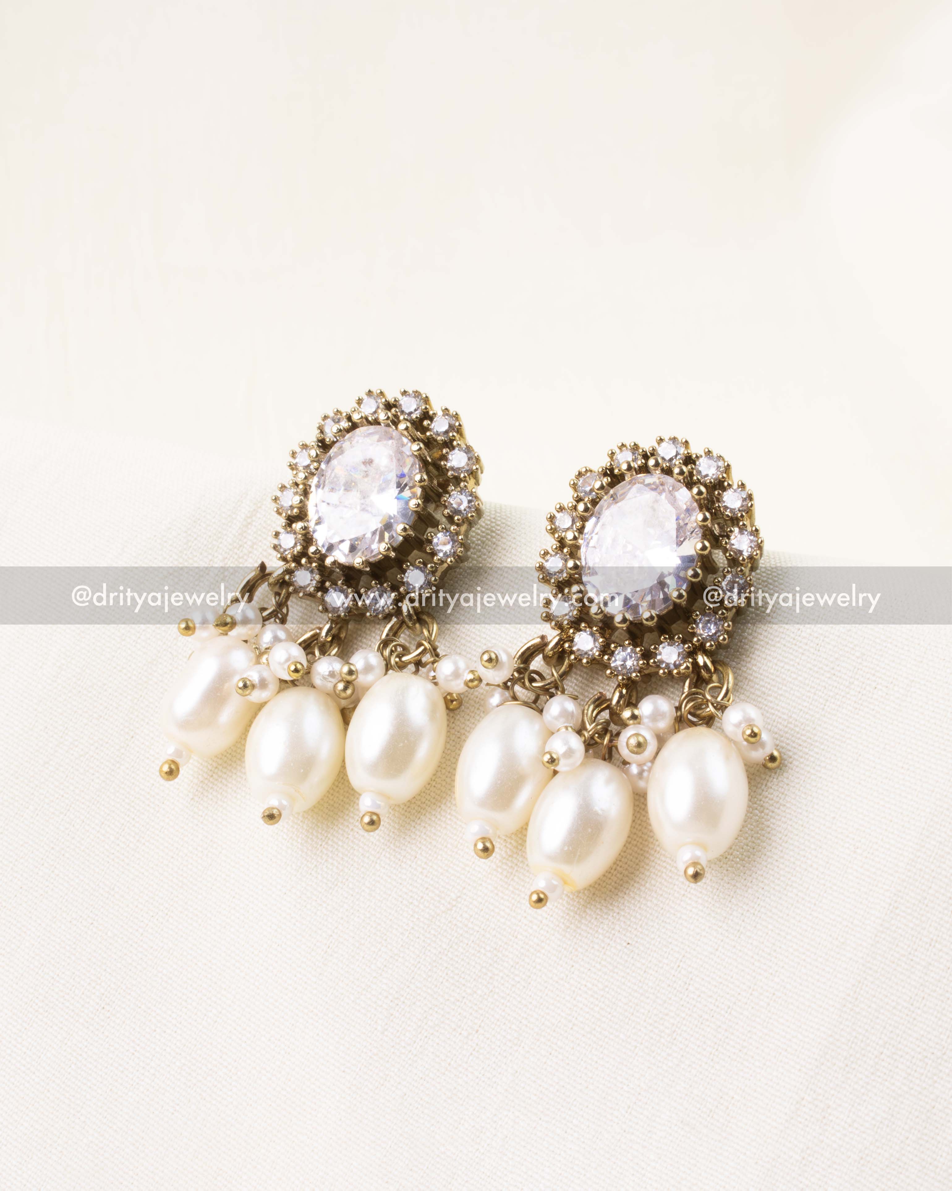 White earrings with pearl danglers and AD setting