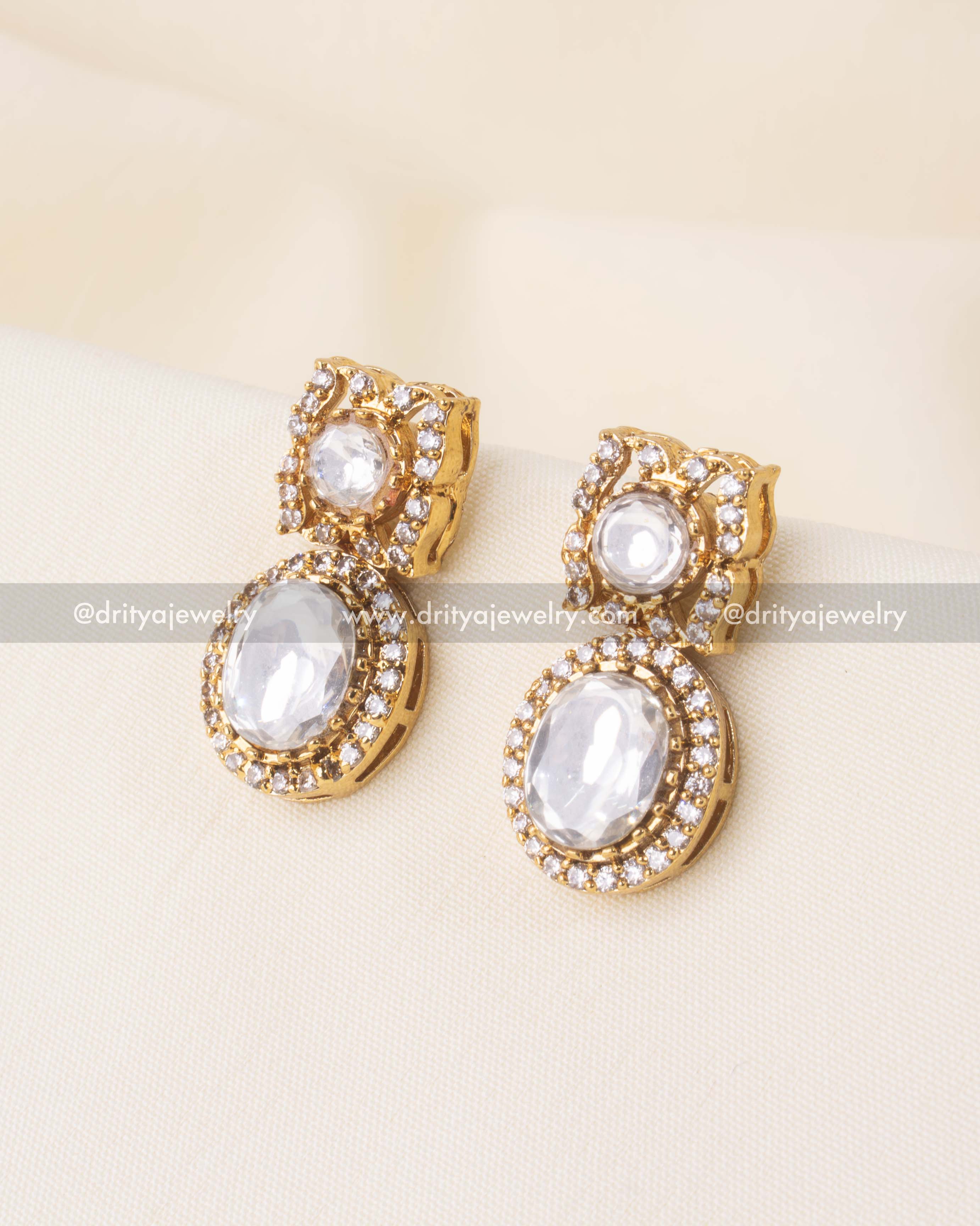 Double kundan earrings in gold tone with red and white accents.