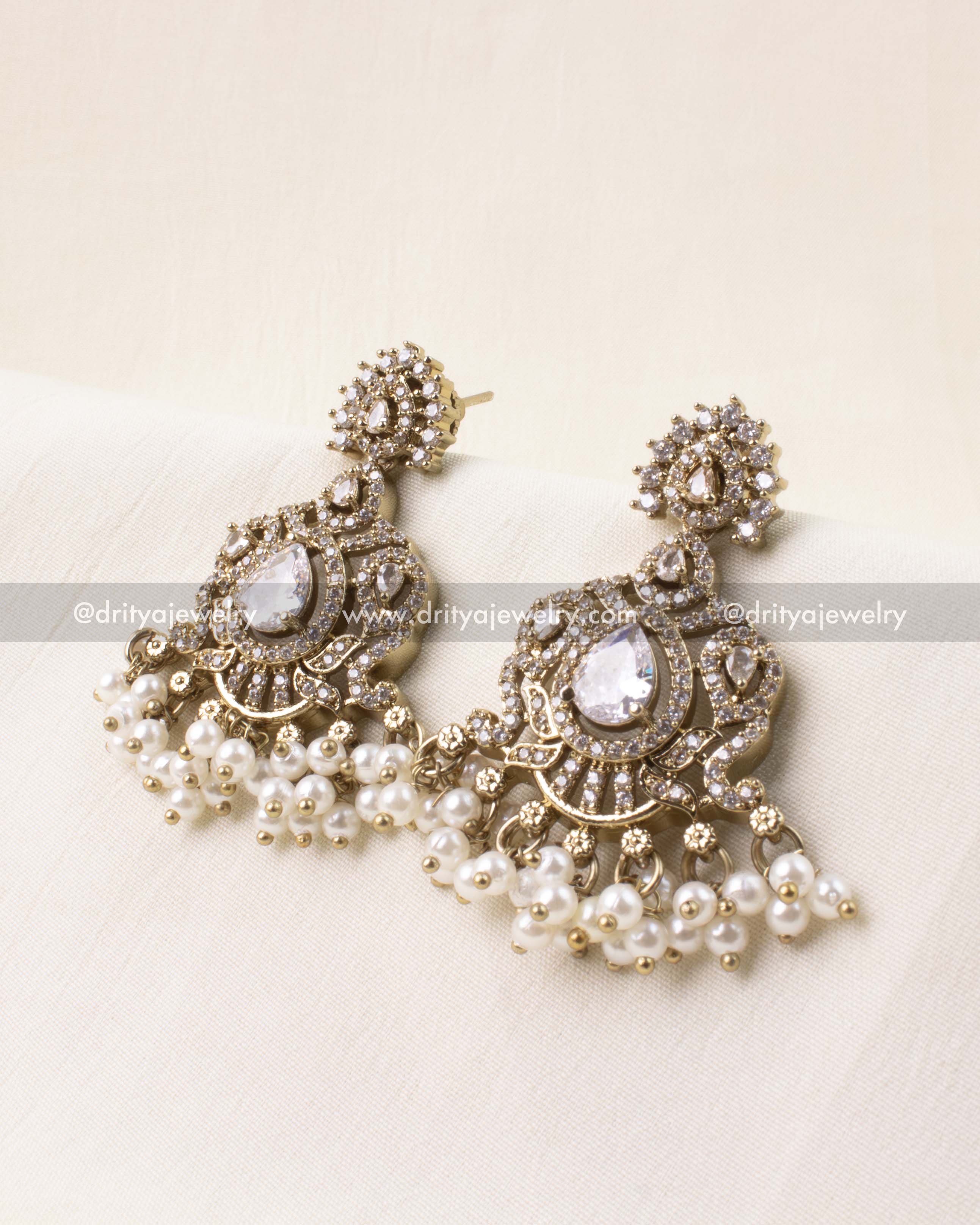 White AD stone earrings with pearl hangings in Victorian design.