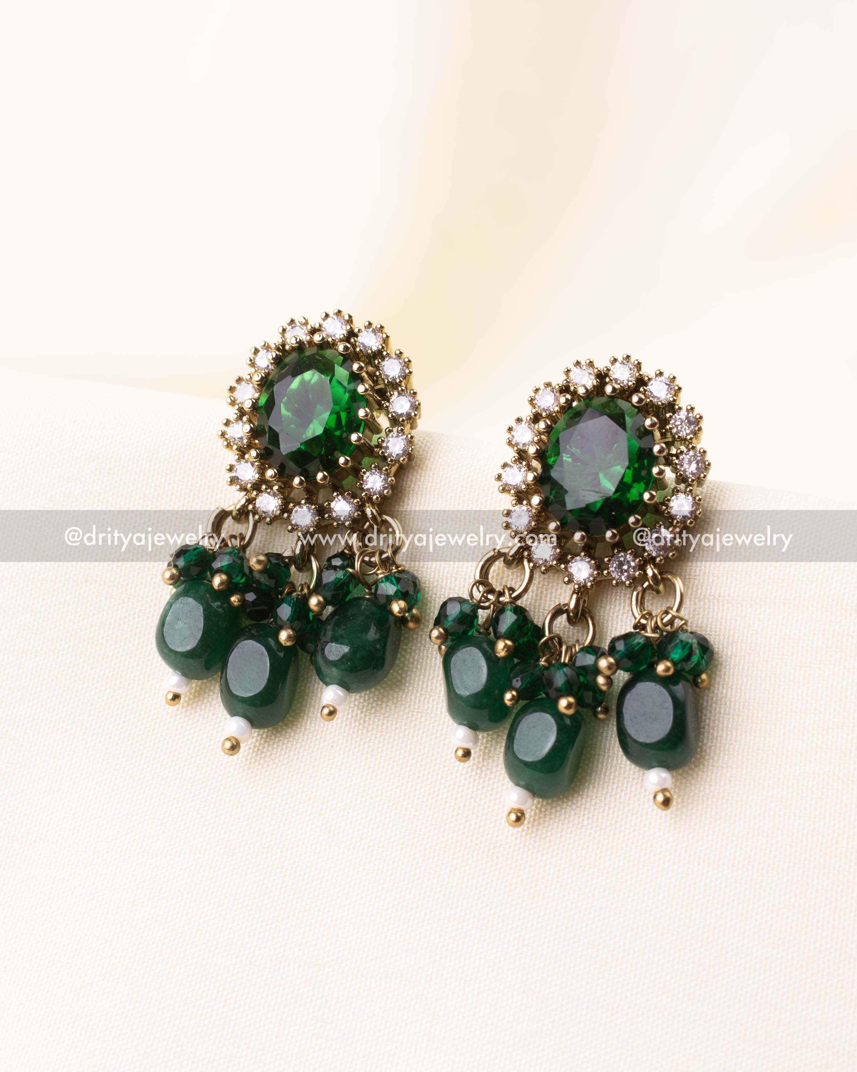 Matching green stone earrings with cluster drop detailing
