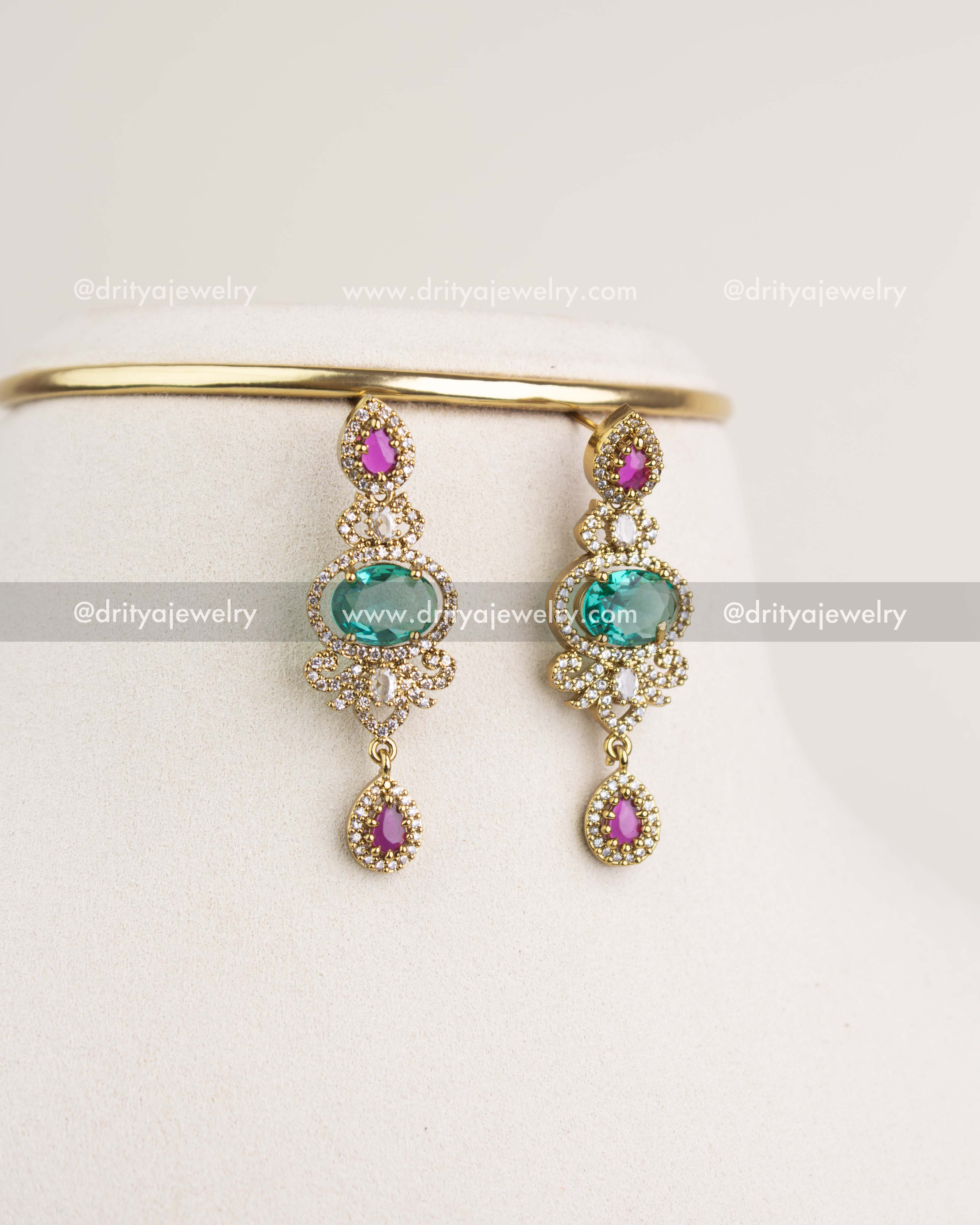 Victorian earrings with Russian emerald stones, ruby teardrops, pearls, and antique gold finish.