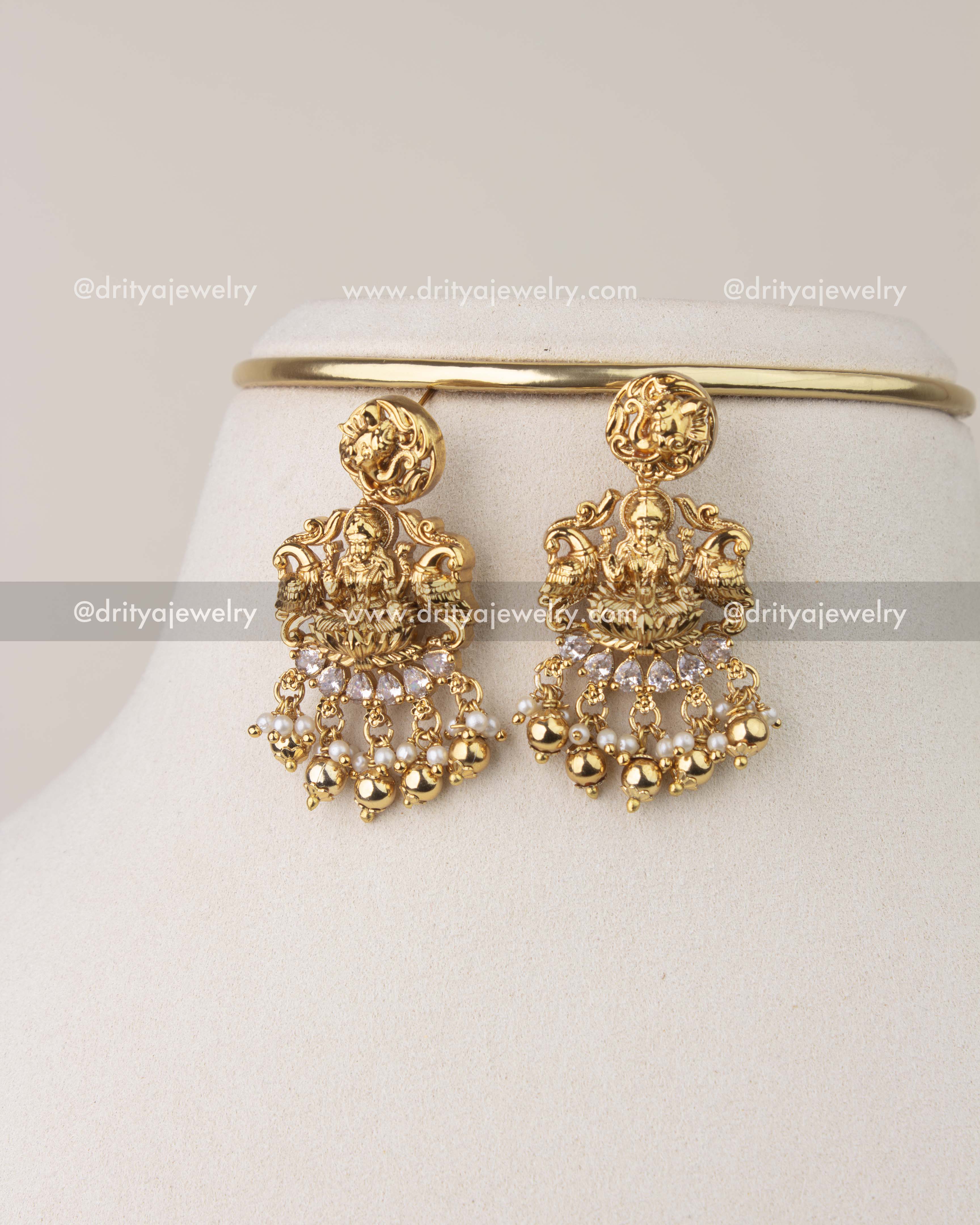 Nakshi temple earrings with Goddess Lakshmi design, pearl chains, and gold drops