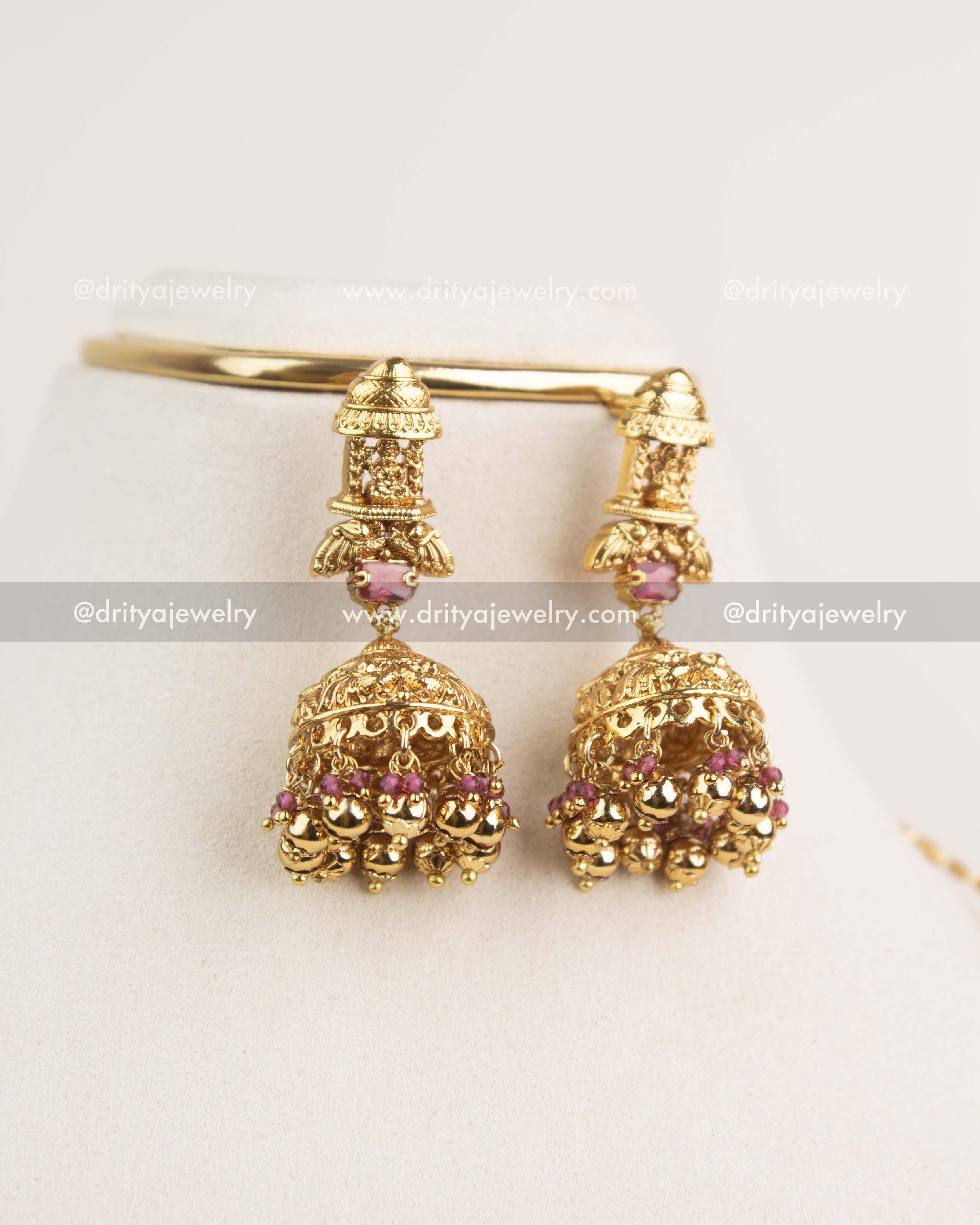 Traditional Nakshi jhumkas with ruby stones and gold bead hangings.