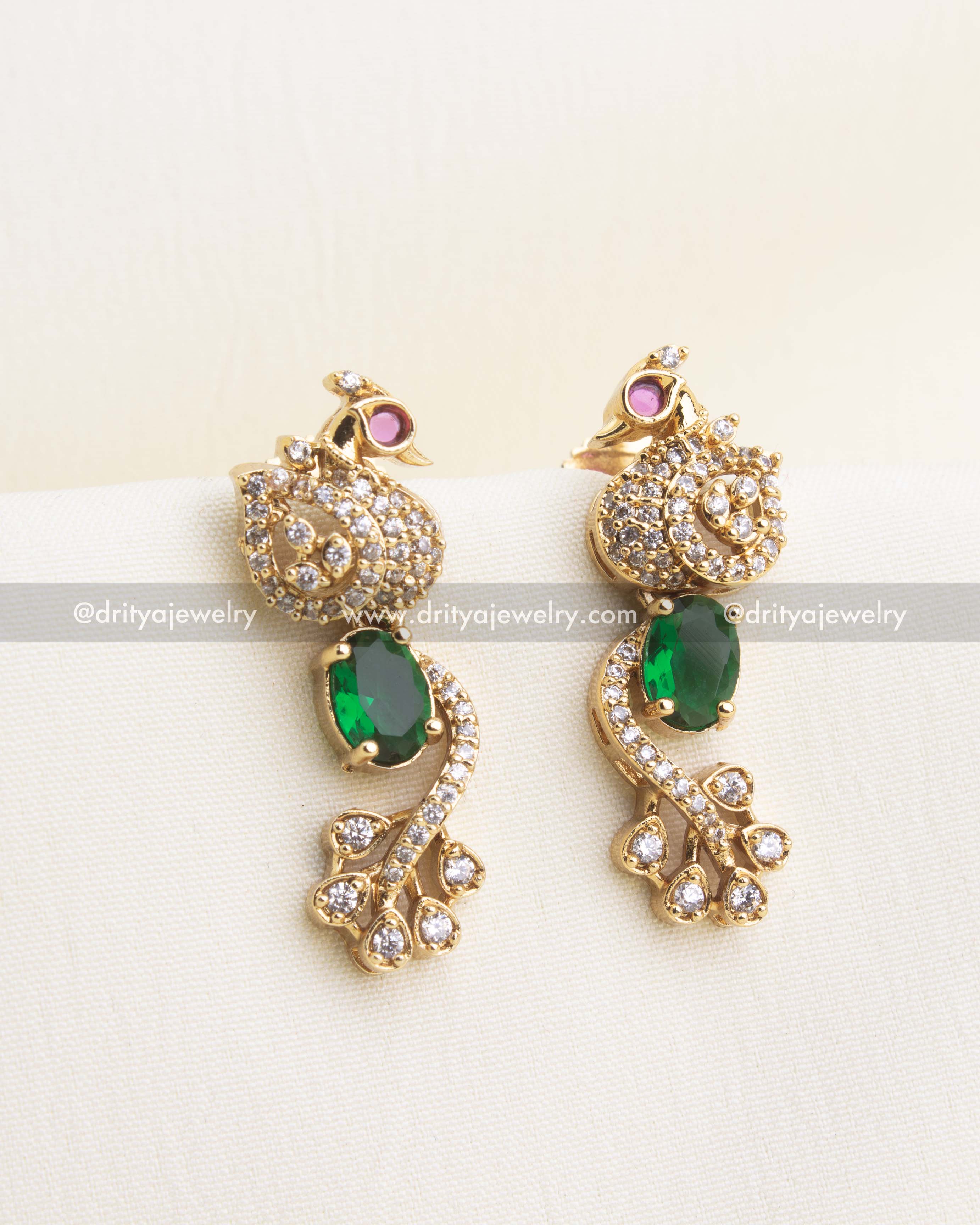 Matching emerald green CZ earrings with peacock top and AD detailing.