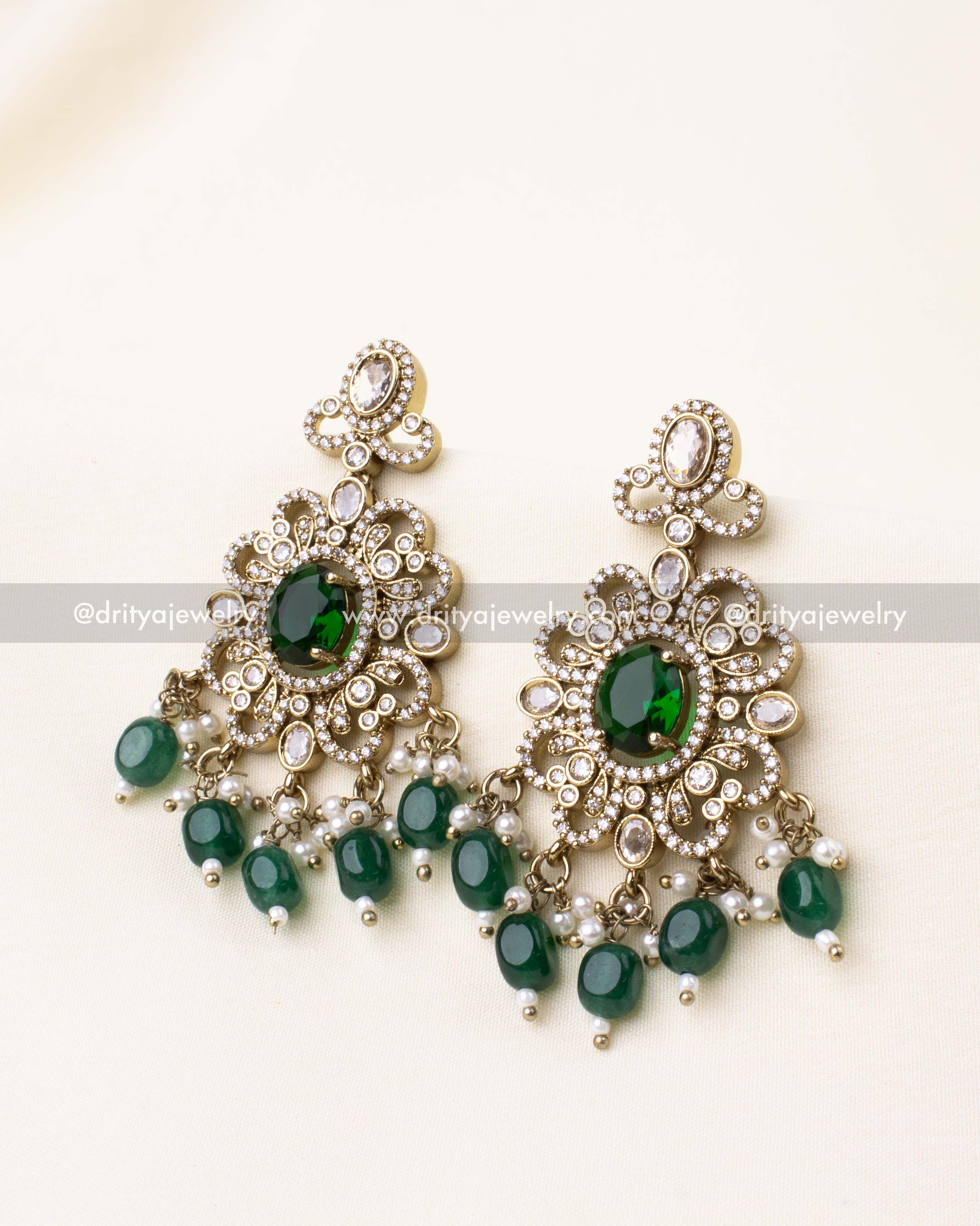 Regal Victorian earrings with emerald green stones and bead detailing.