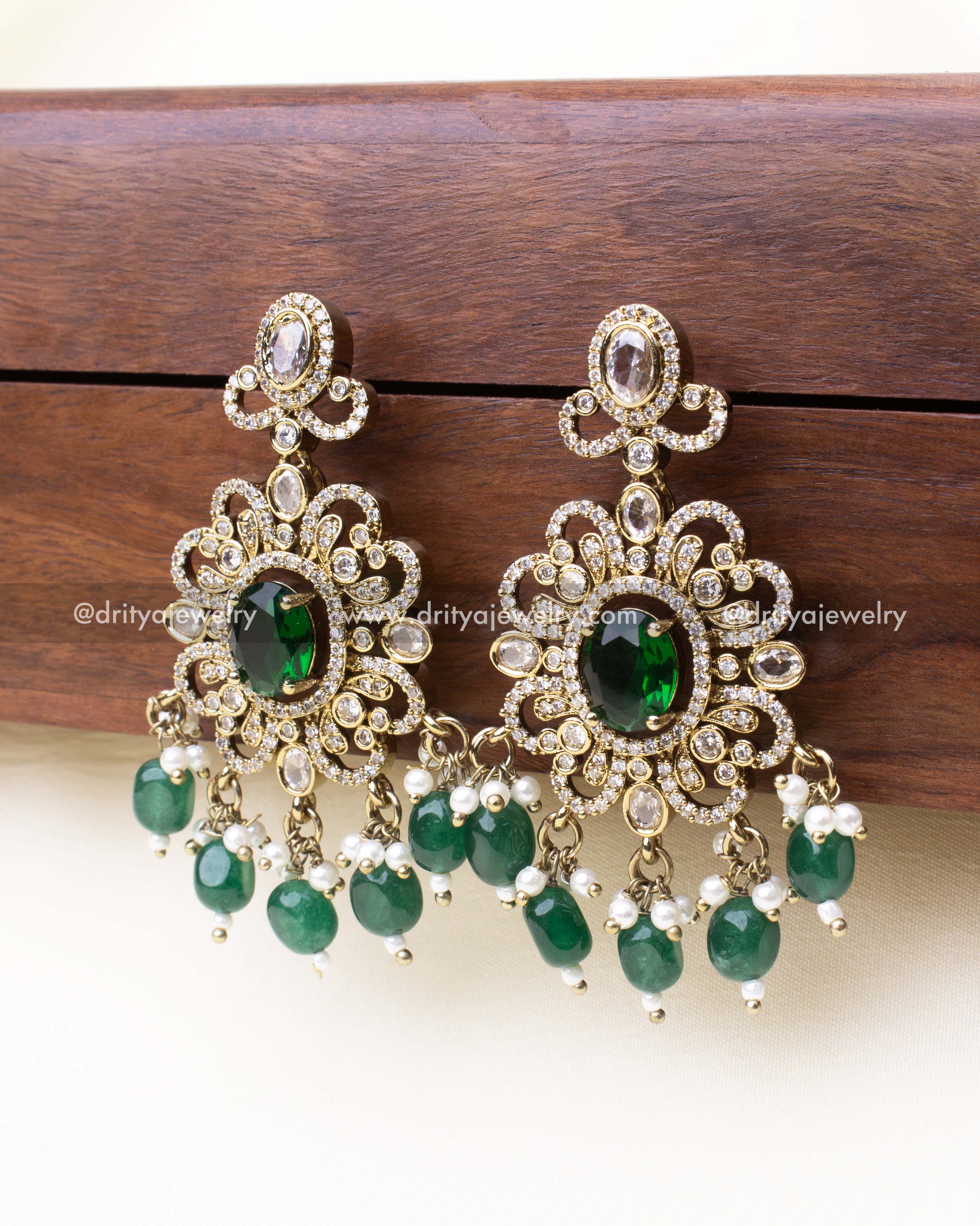 Emerald-toned drop earrings with antique gold finish and CZ stones.