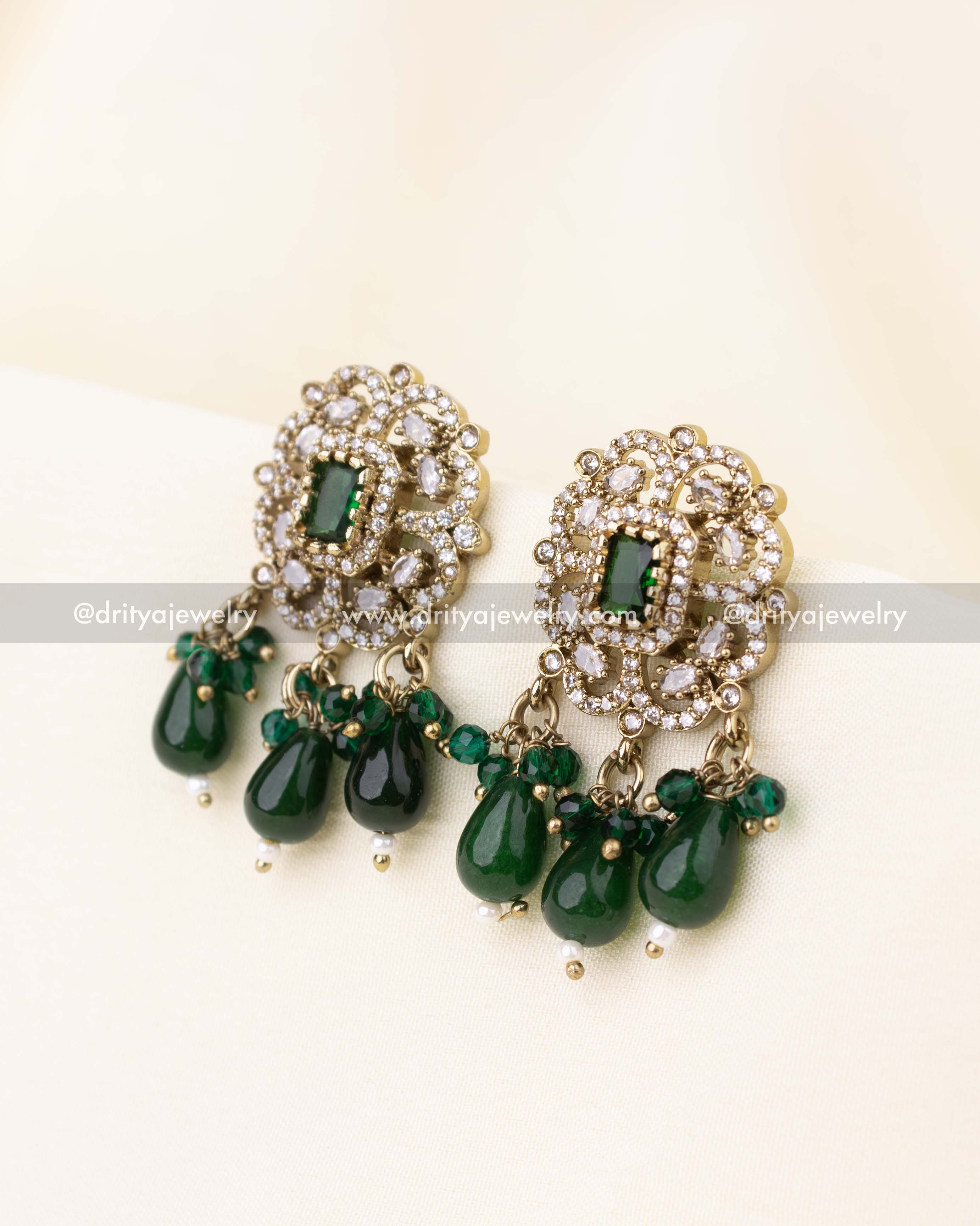 Victorian stud earrings with emerald green bead drops.