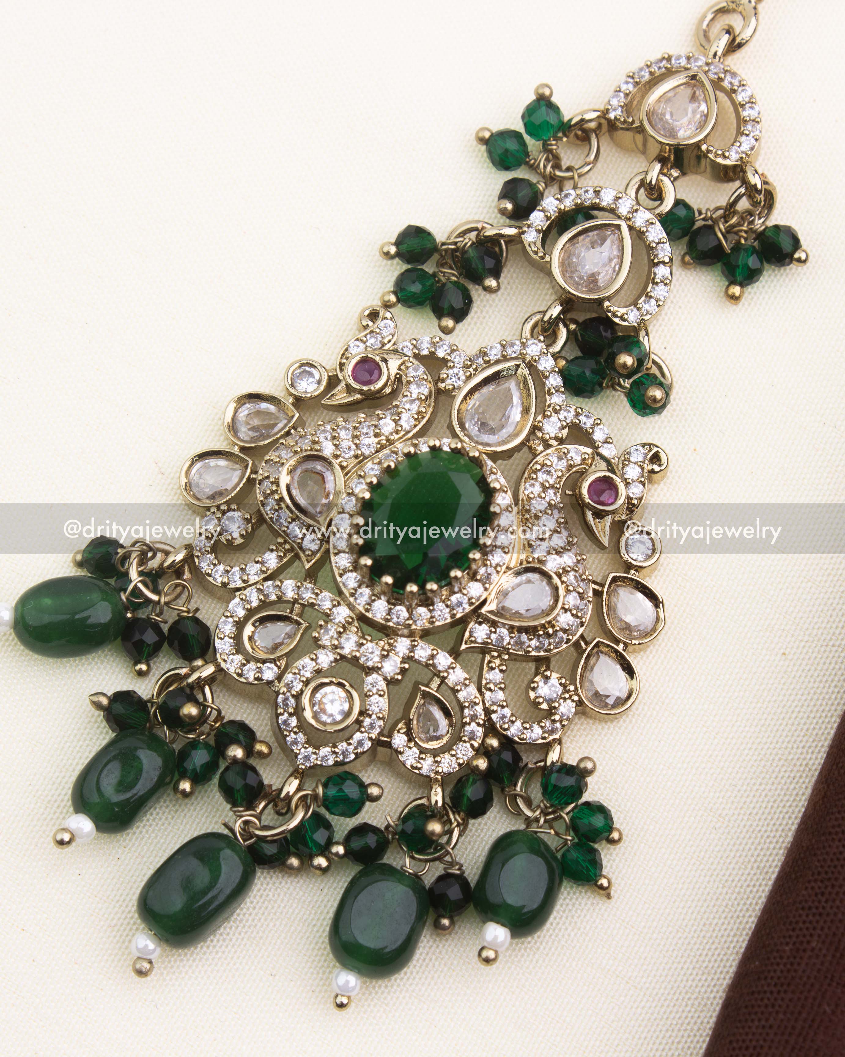 Close-up showing emerald green center stone, AD embellishments, and Victorian filigree work