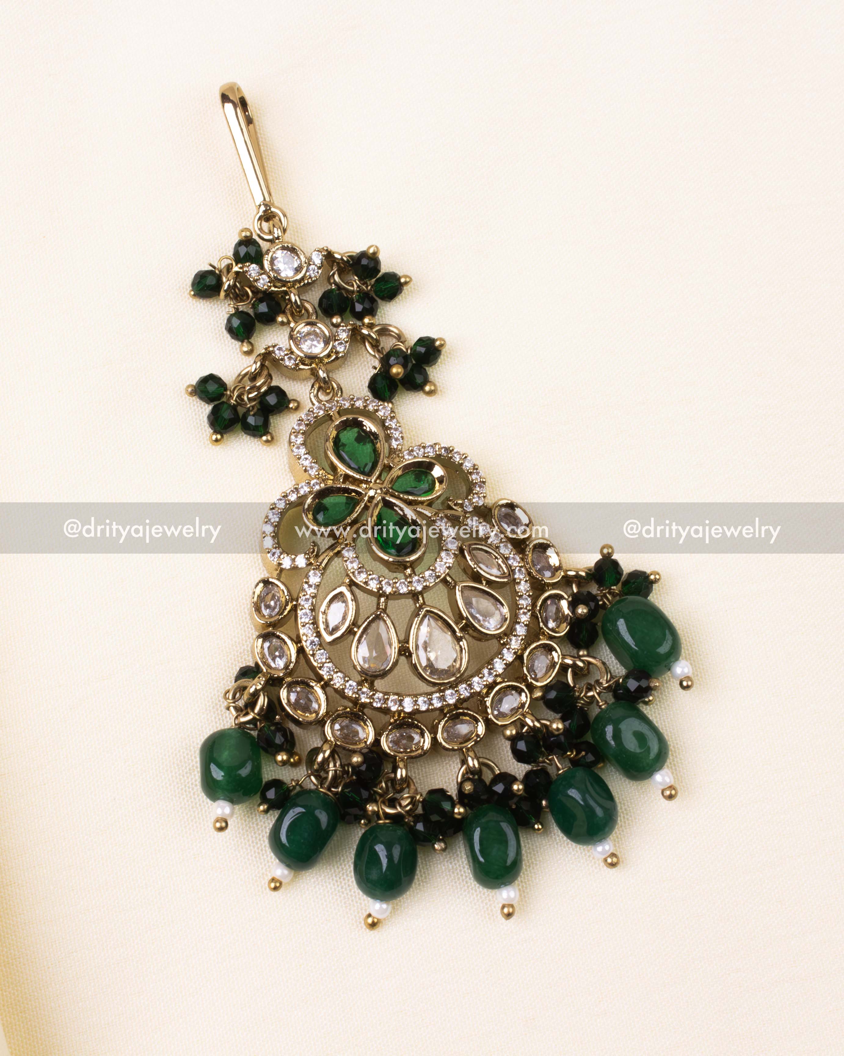 Antique-style tikka with emerald green centerpiece and pearl-detailed fringe.