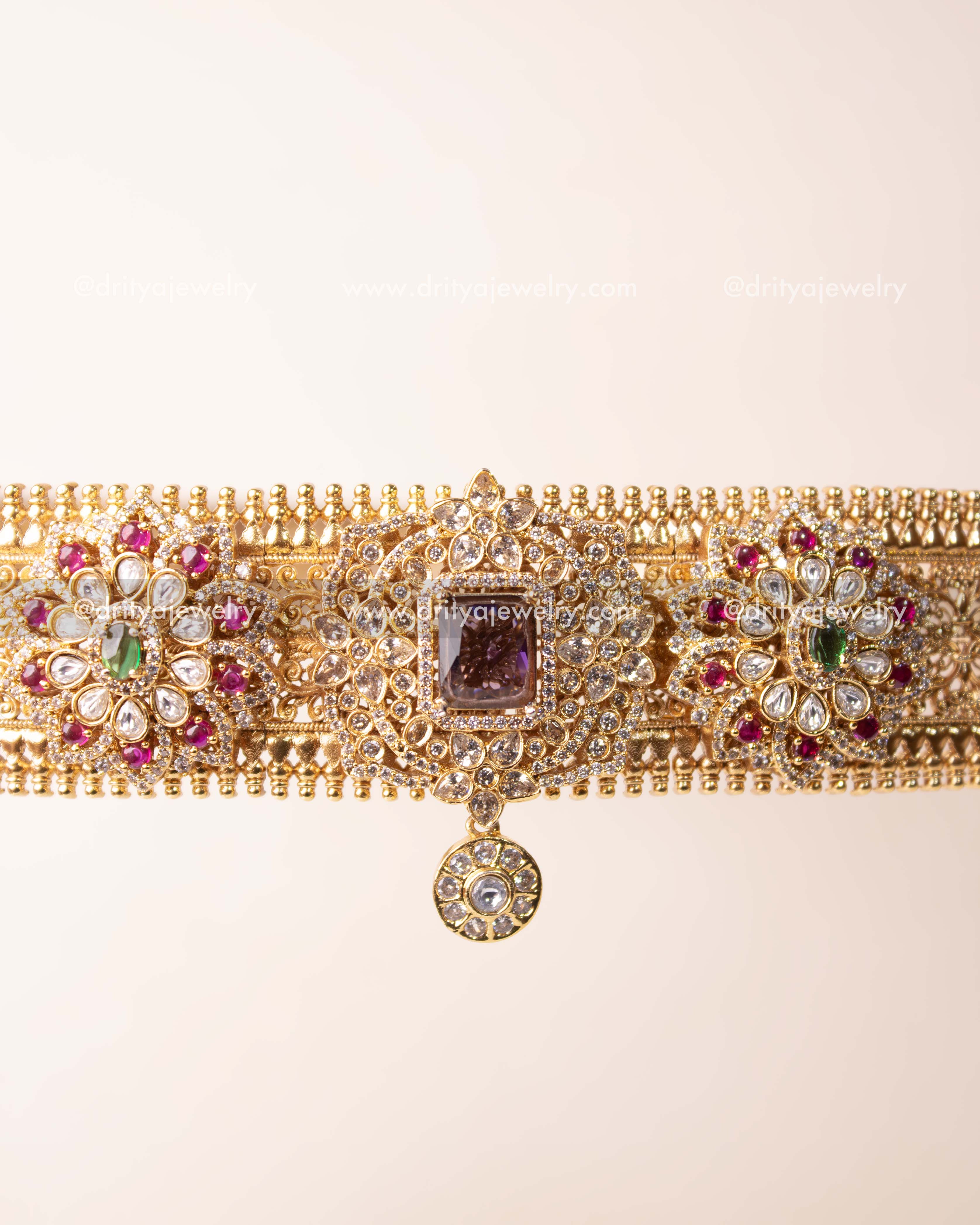 Front angle highlighting the central AD stone and symmetrical floral motifs of the belt.