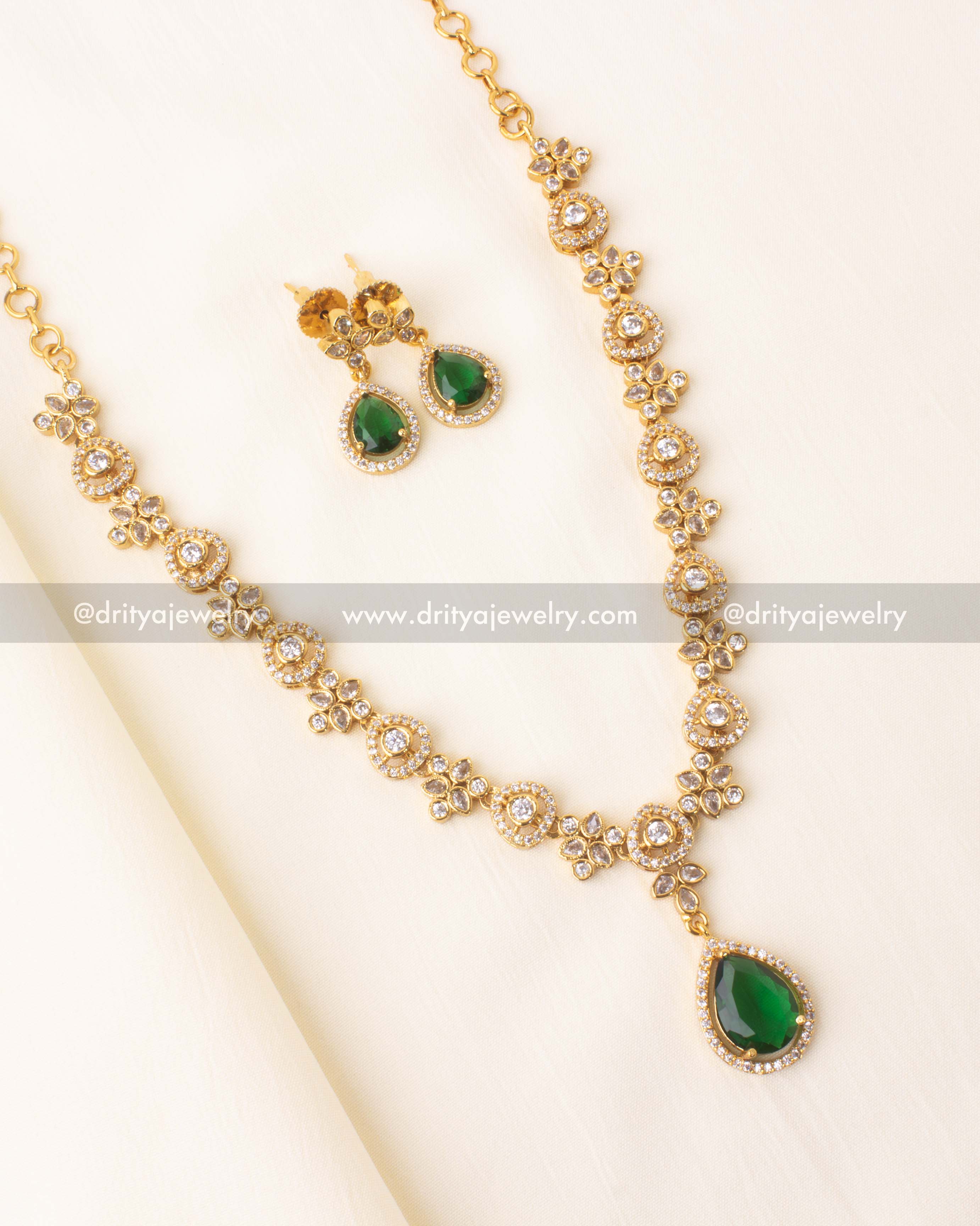 Green stone short necklace set with floral CZ accents and matching earrings.