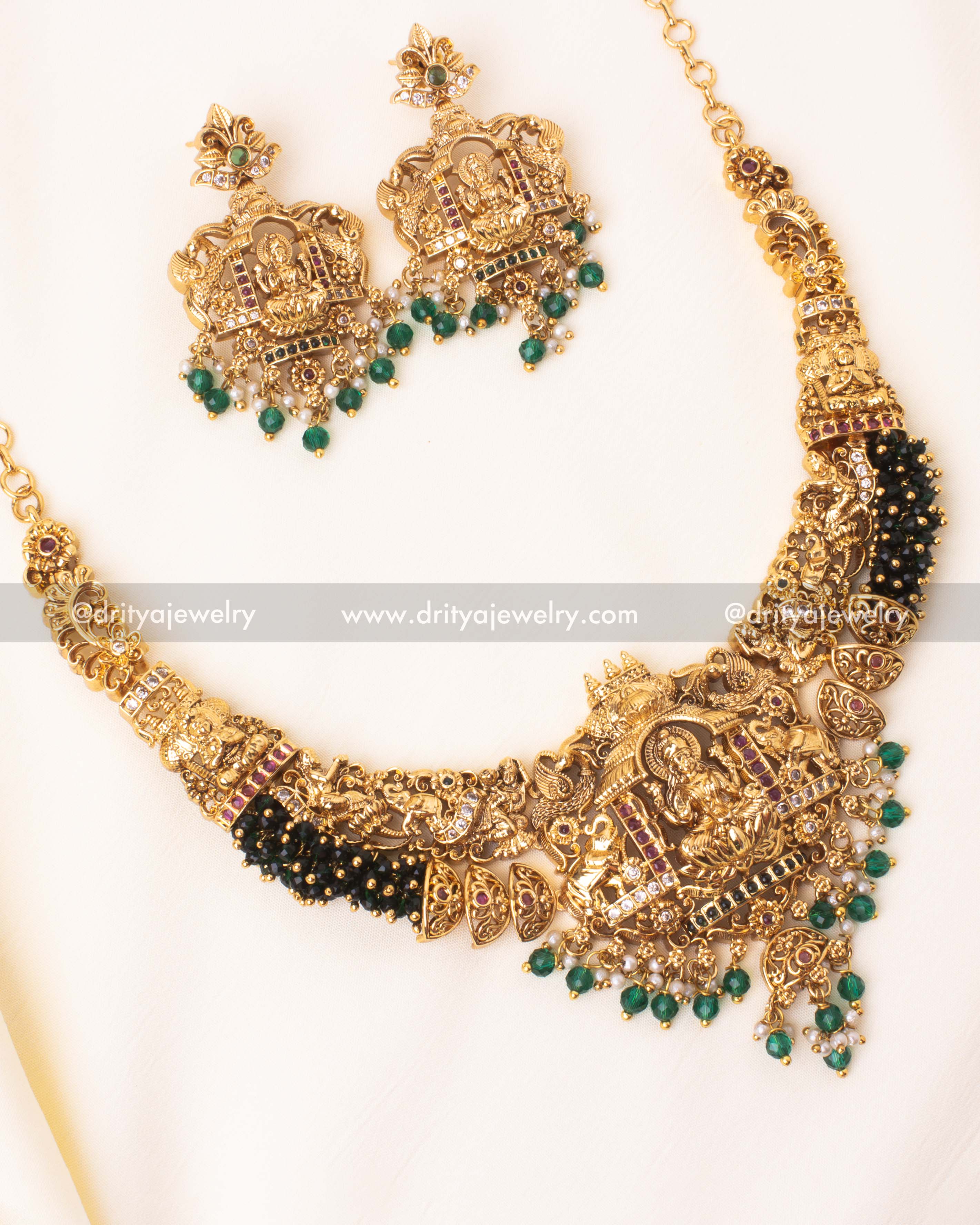 Majestic temple-style Nakshi Gutta Pusalu necklace with Lakshmi motif and emerald green bead drops.