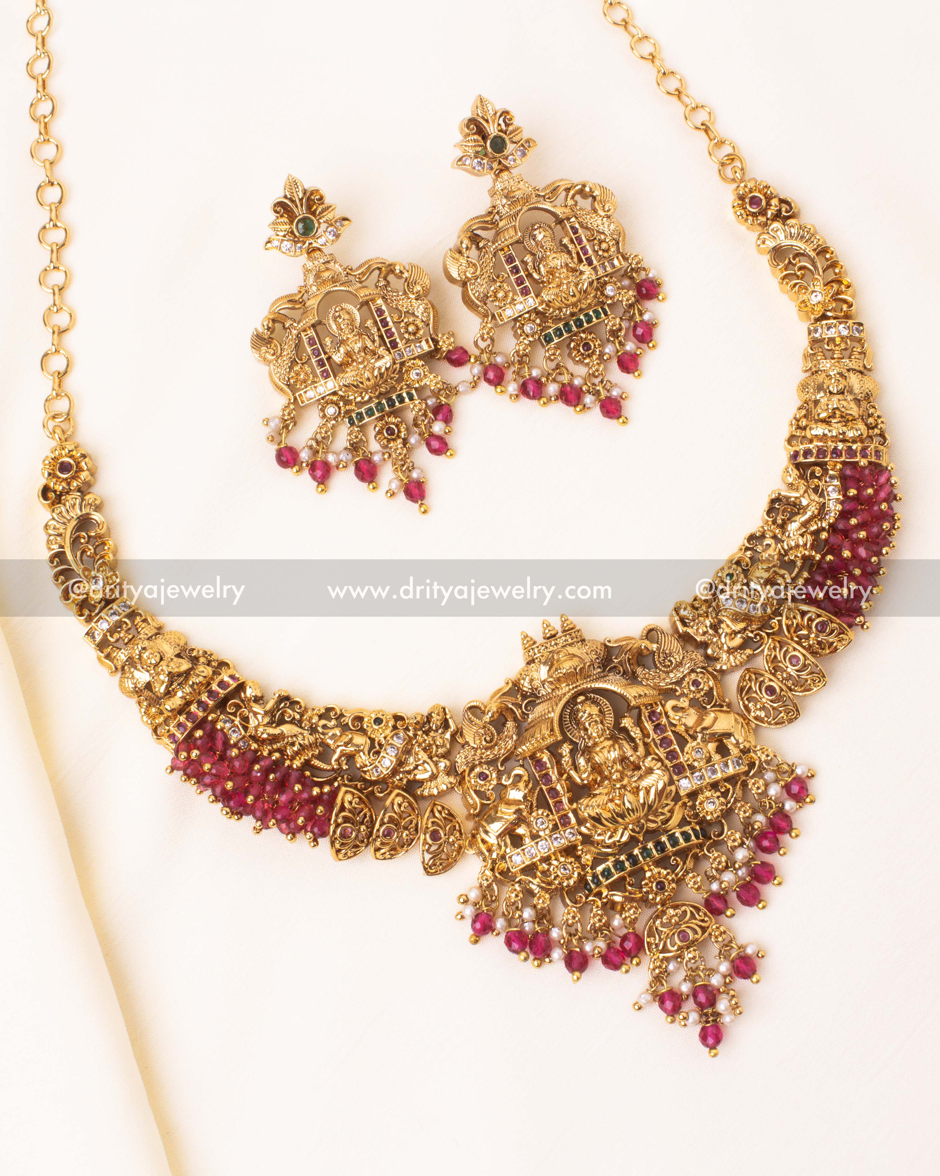 Exquisite temple-inspired Nakshi Gutta Pusalu necklace with Lakshmi motif and ruby red beads.