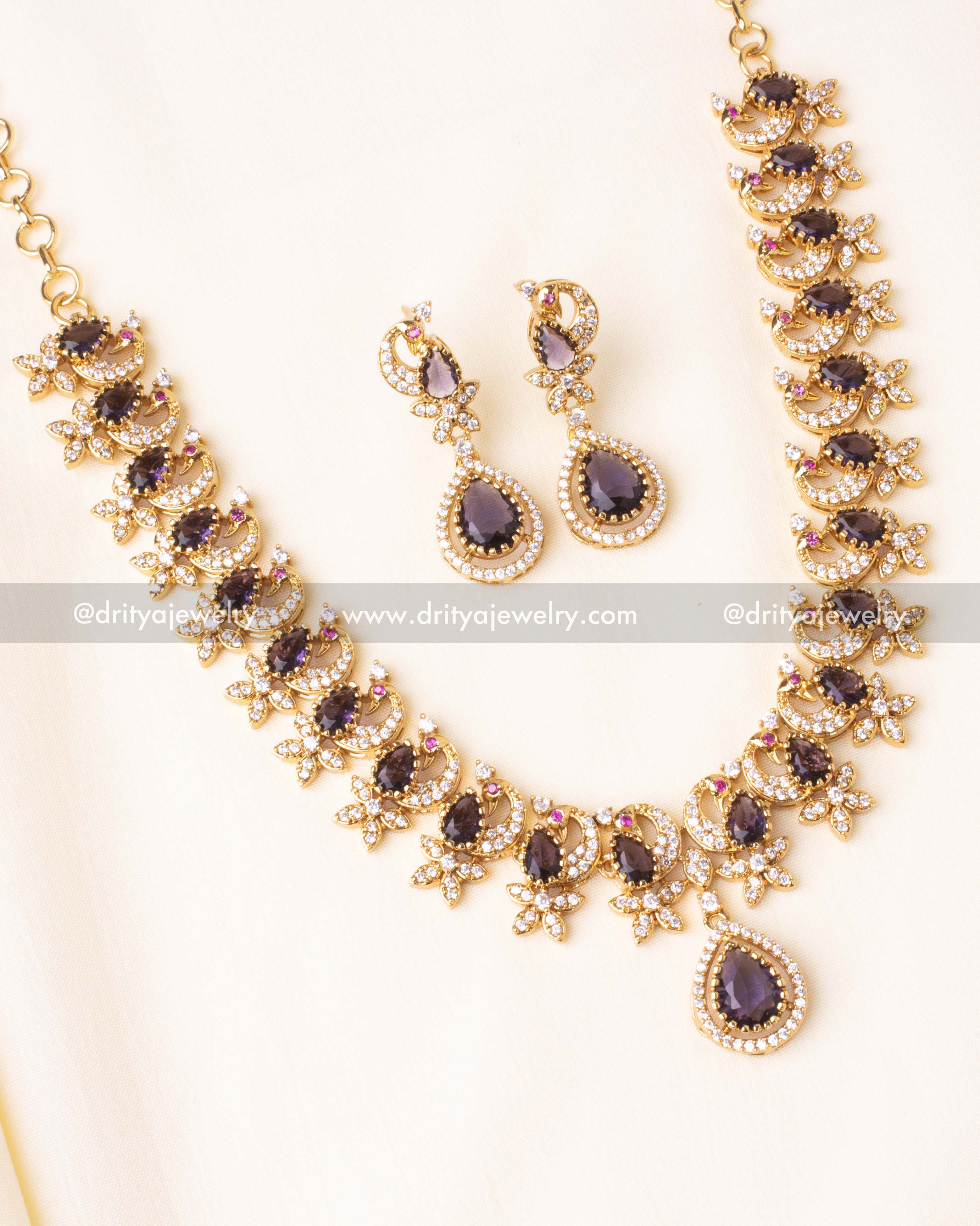 Stunning short necklace set with peacock-inspired design, purple gemstones, and CZ stones.