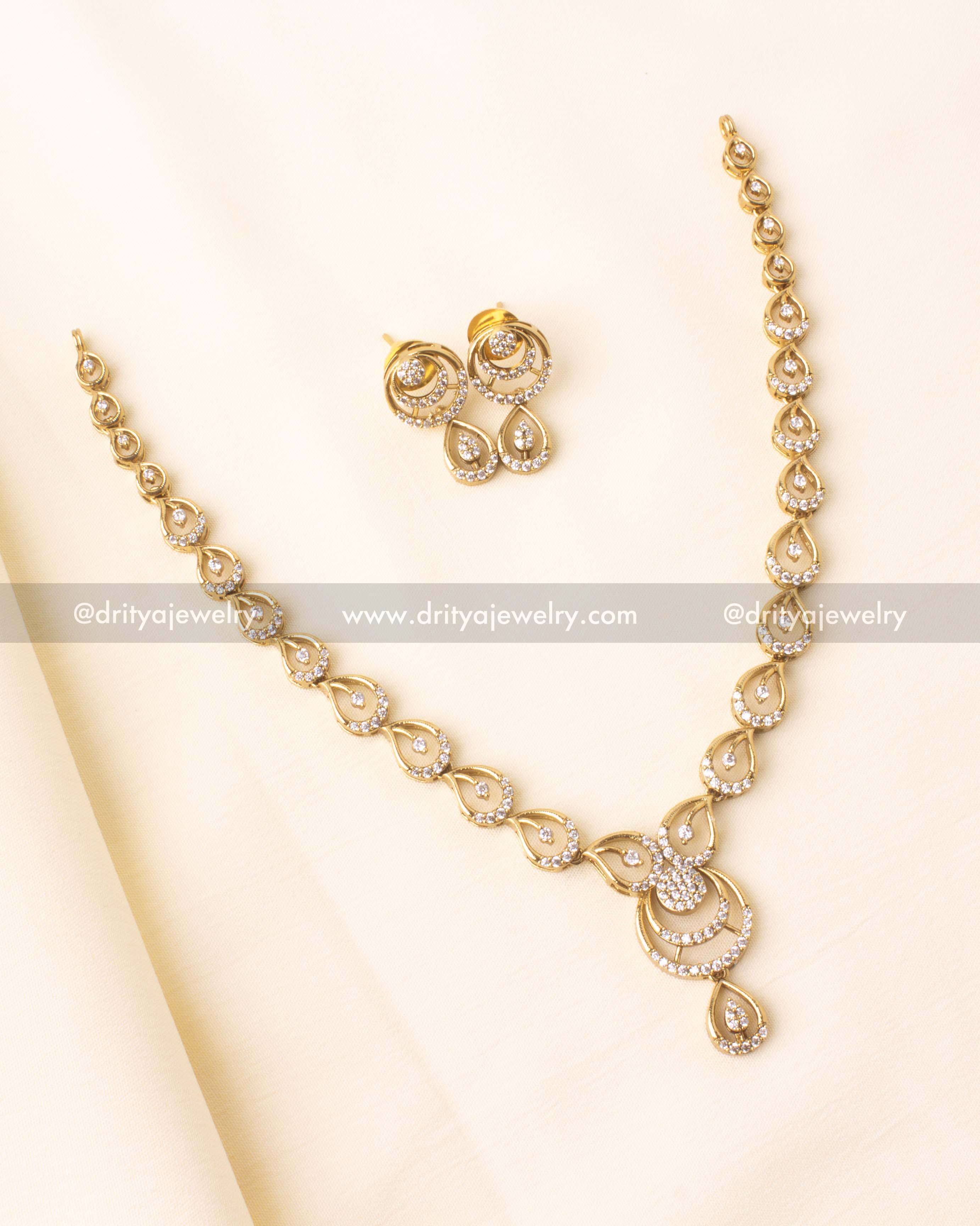 Short necklace with gold finish and CZ-studded tear-drop designs.