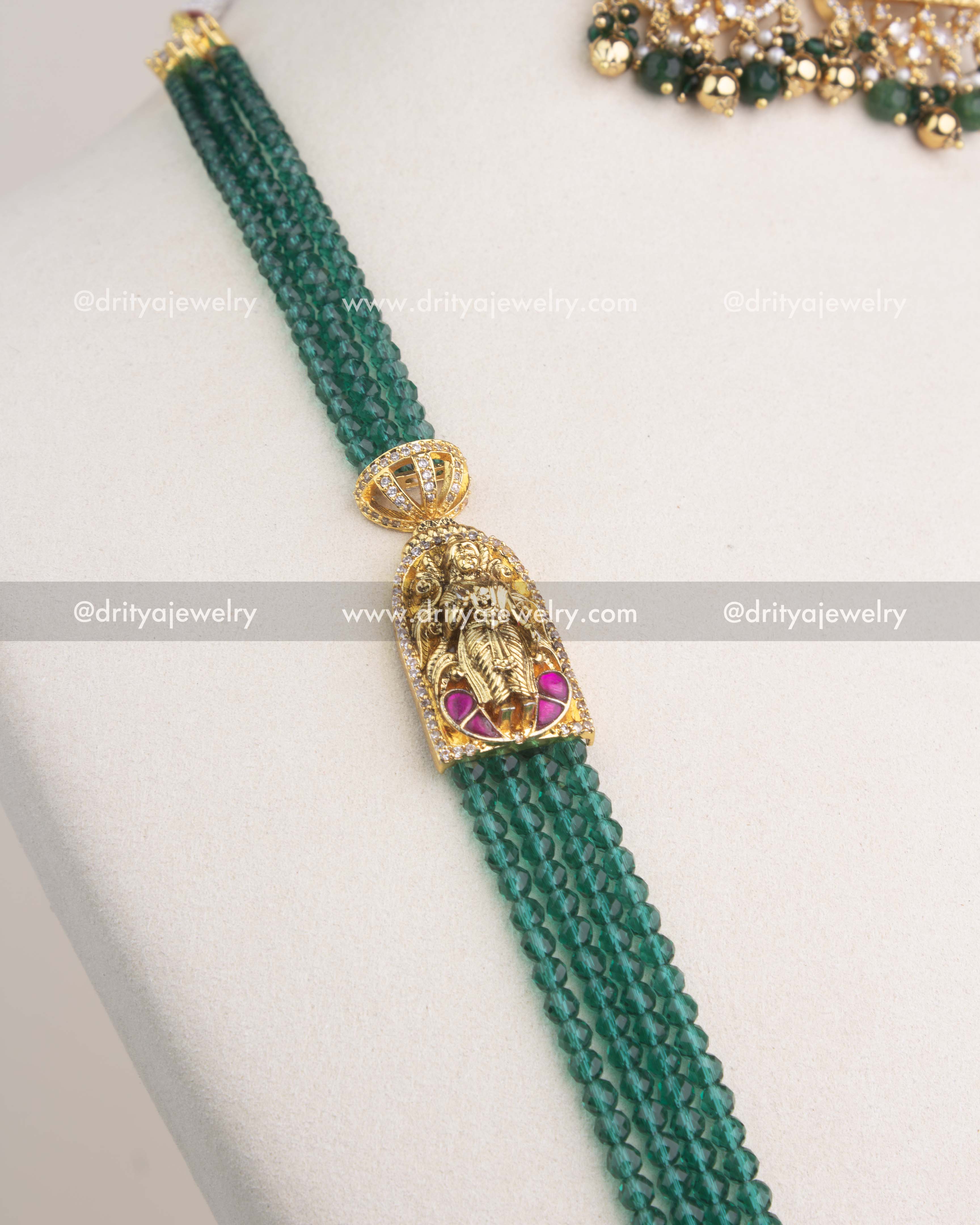 Multi-layer strands of green faceted beads attached to antique gold temple connectors.
