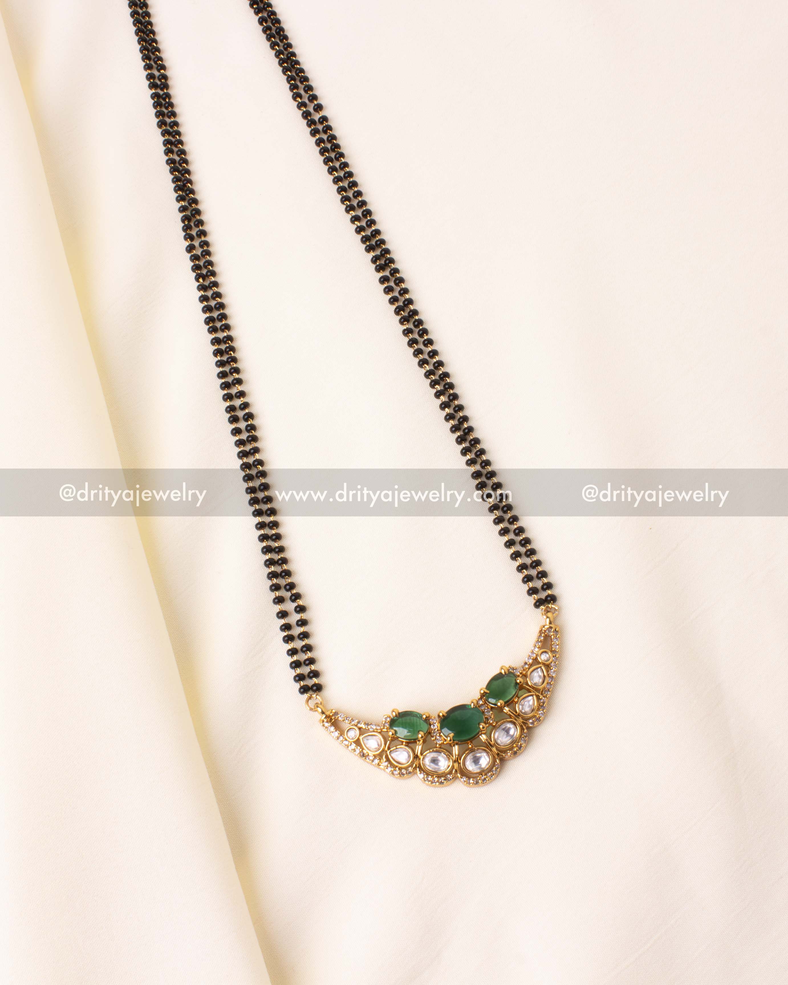 Premium black beads necklace with green moissanite stones, kundan detailing, and gold-plated finish.