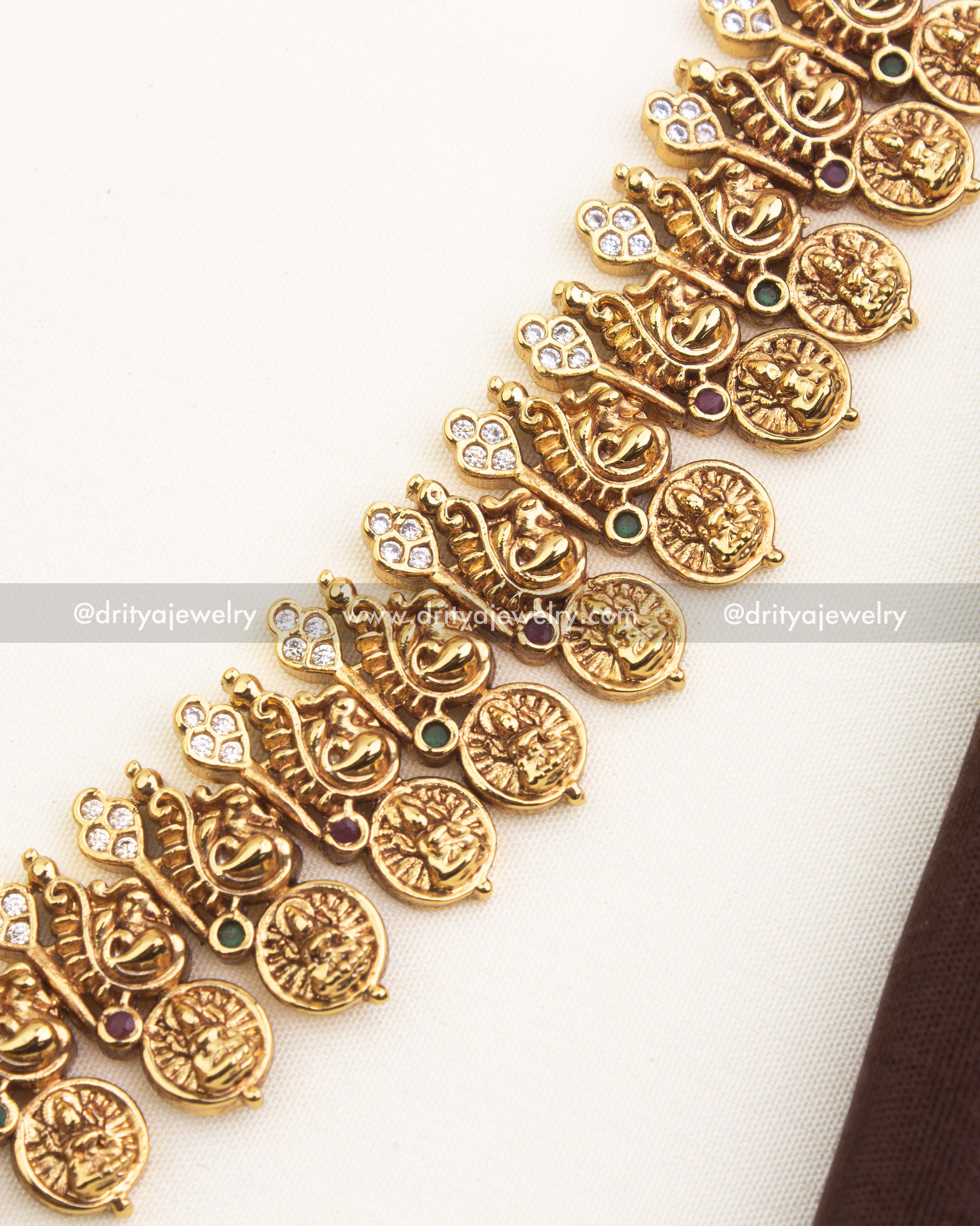 Close-up of ornate kasulu coin chain with antique gold temple finish.