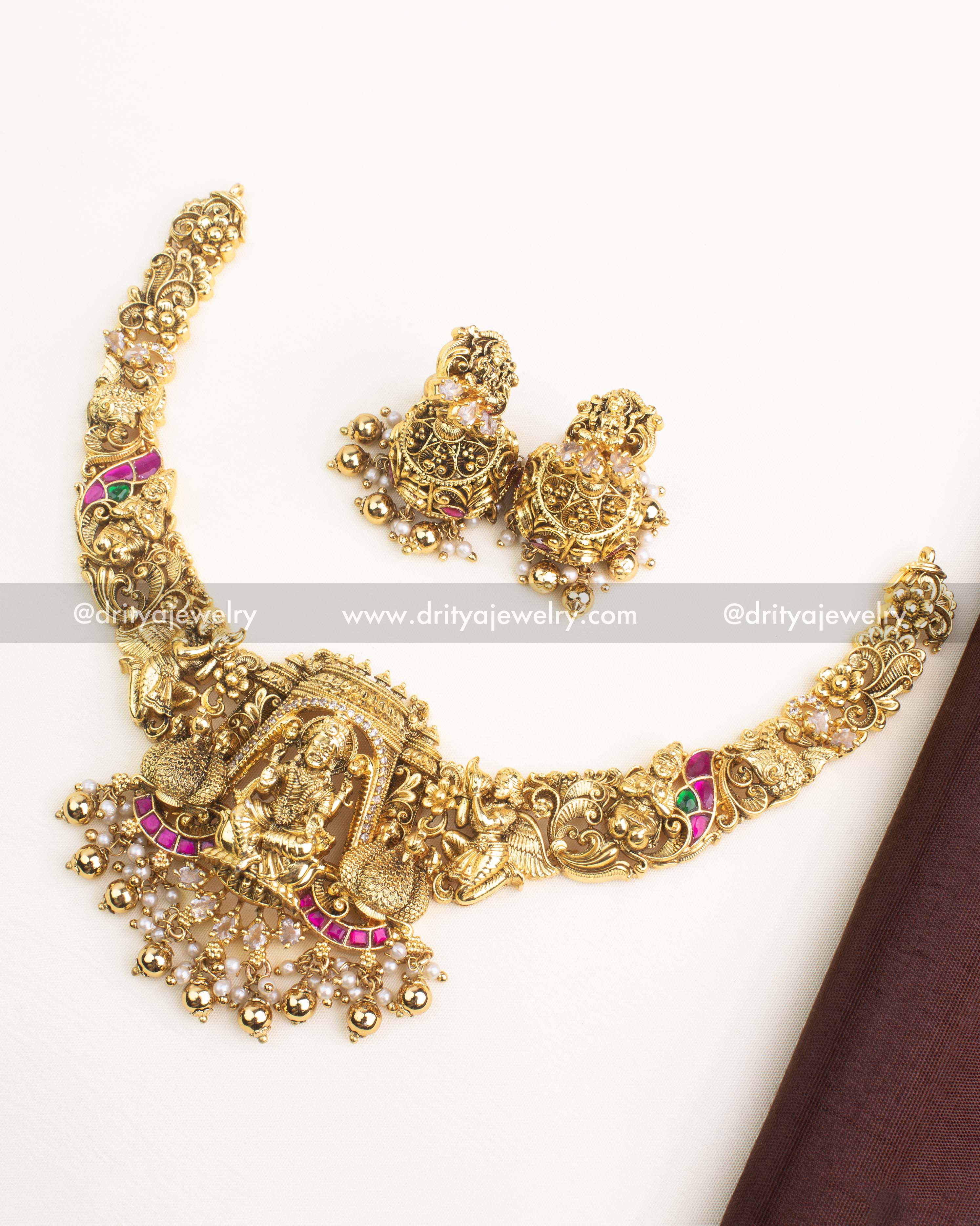 Premium temple jewelry short necklace with Lakshmi motif, kemp stones, nakshi work, and matching jhumkas.