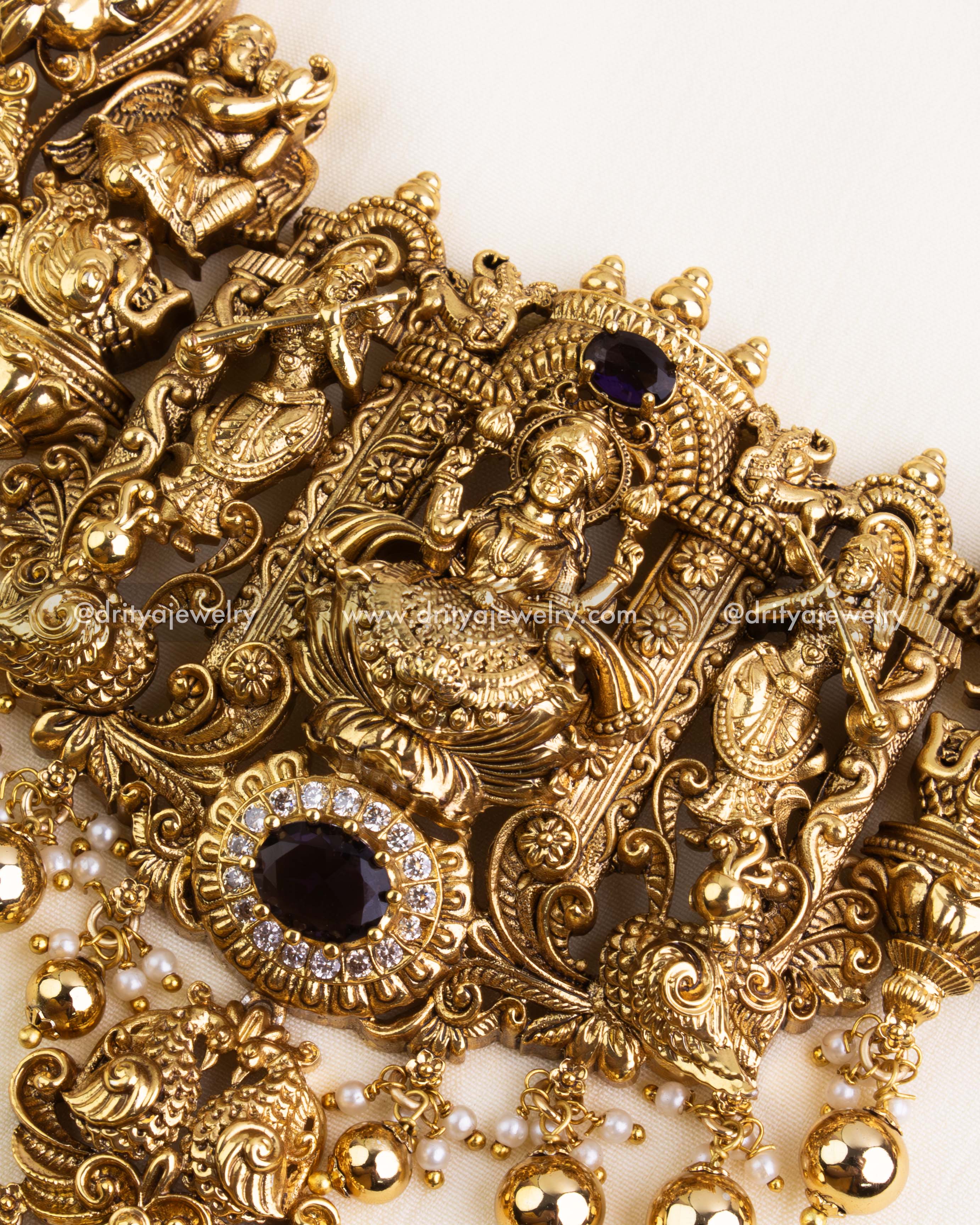 Side angle showing Nakshi chain links with precision-cut CZs and square purple stones arranged in alternating floral motifs