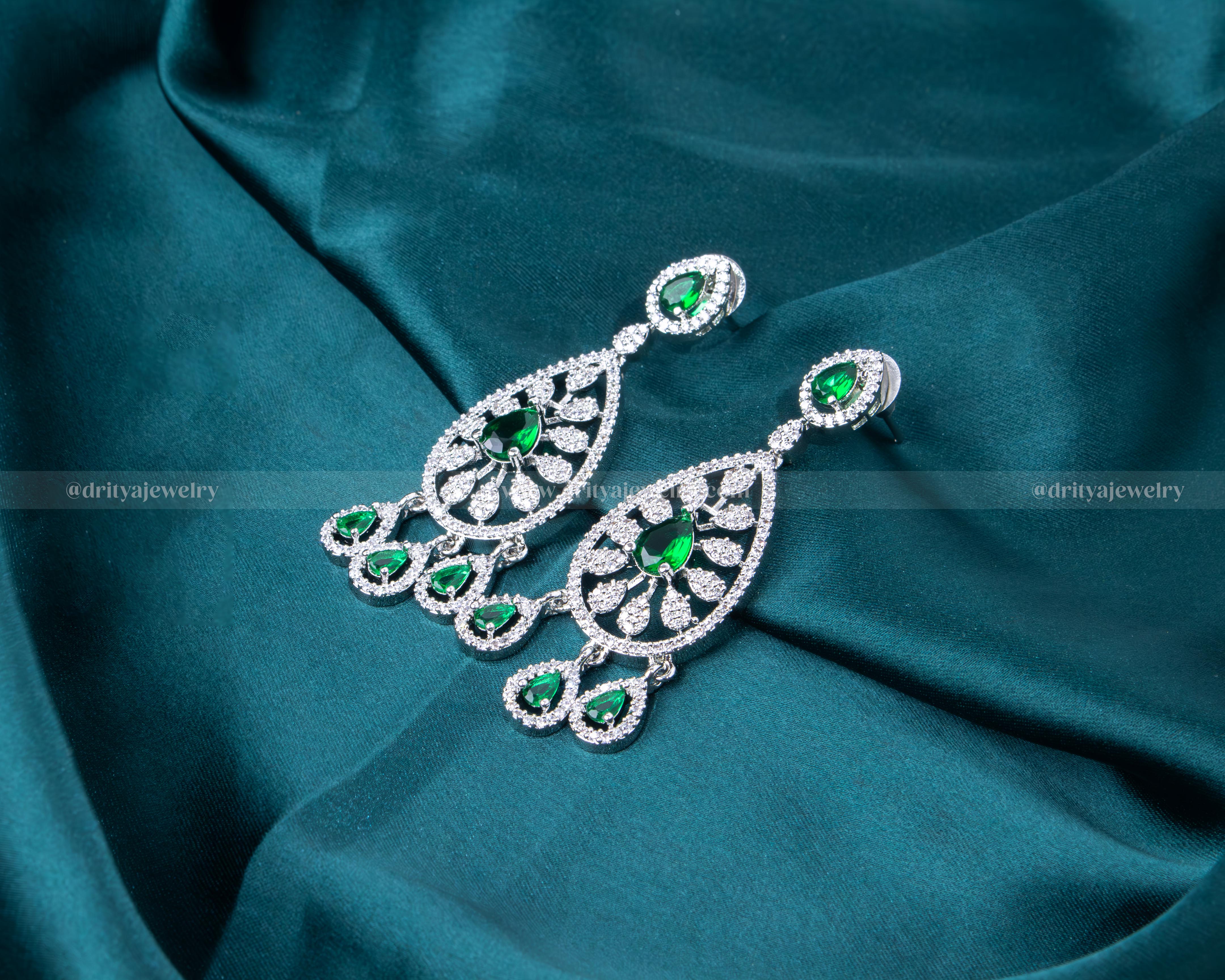 Elegant rhodium-plated necklace set with emerald and CZ stones, perfect for special occasions and formal events.