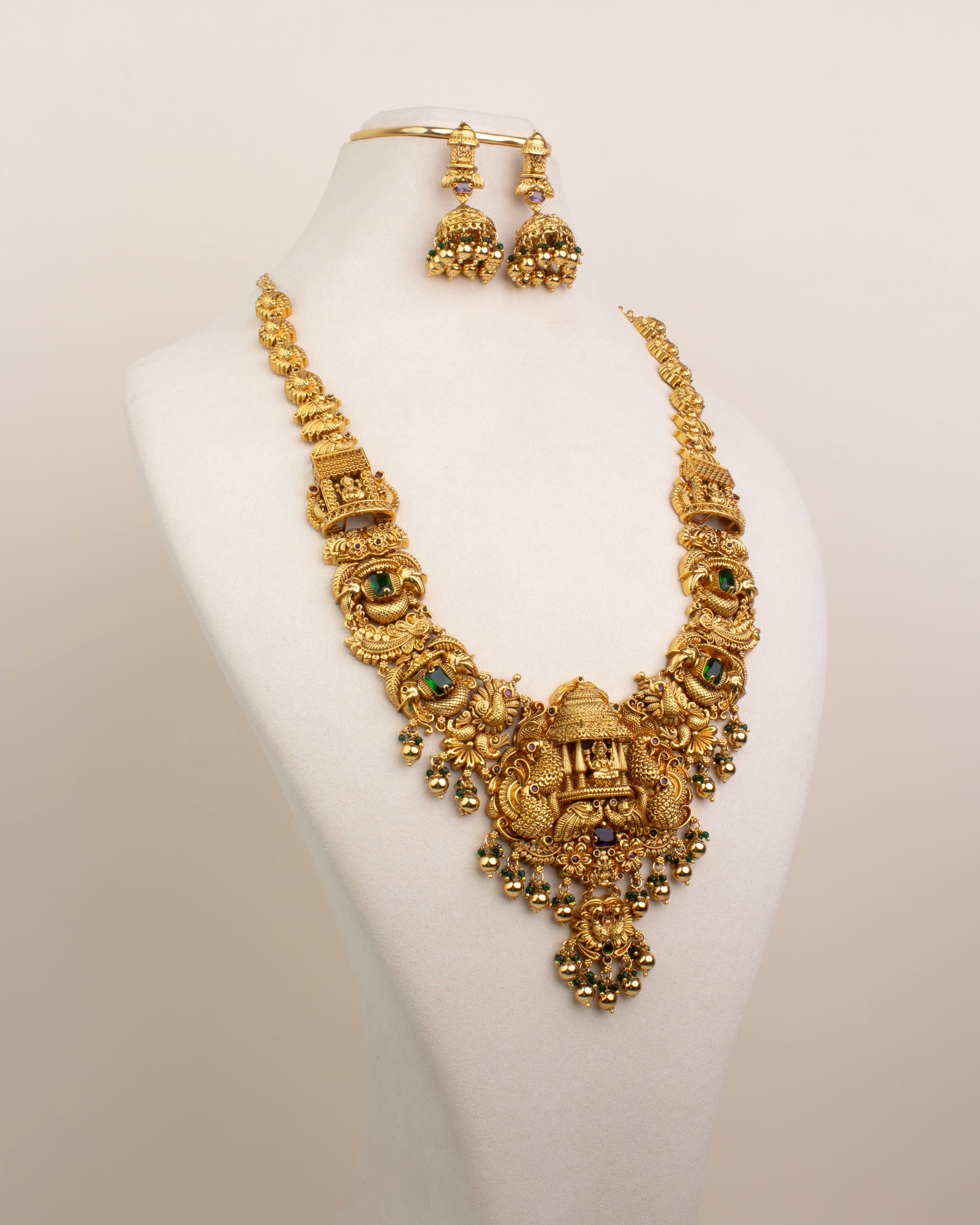 Full view of Nakshi Temple Long Necklace Set with jhumkas on bust – antique gold with green and purple accents