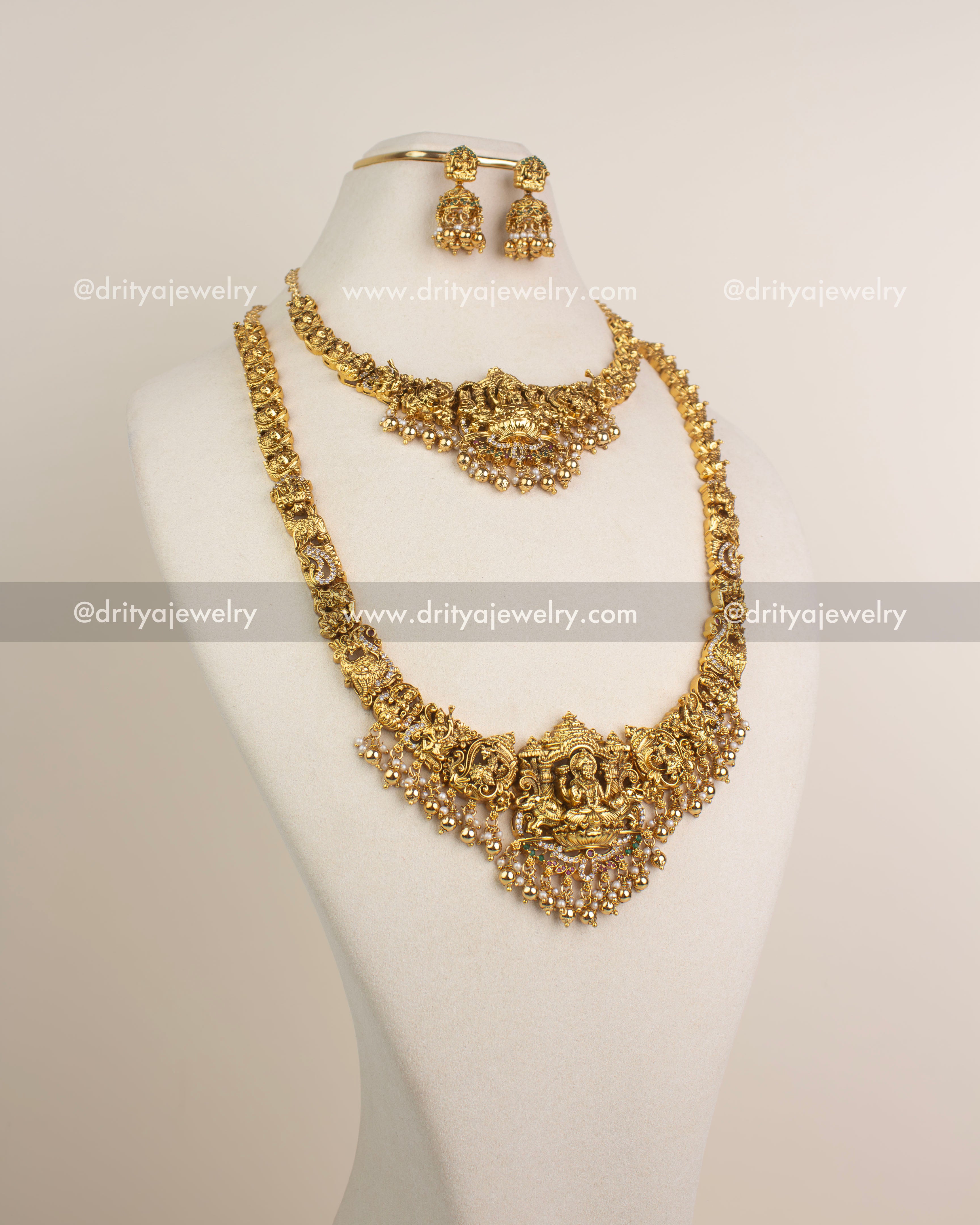 Antique gold nakshi temple long haram featuring Lakshmi pendant, pearl clusters, and deity carvings