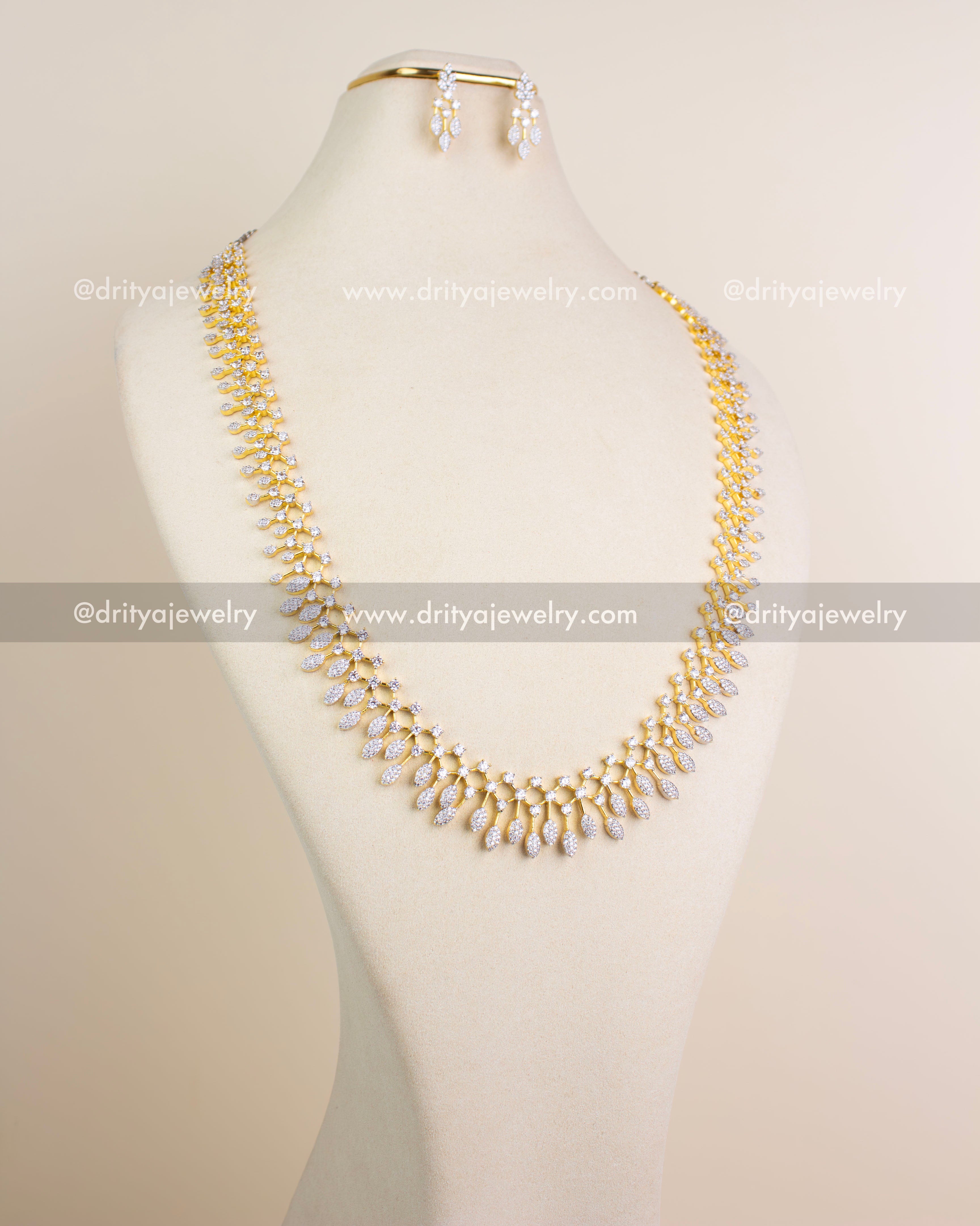 Long diamond replica necklace set in GJ polish with matching earrings displayed on mannequin.