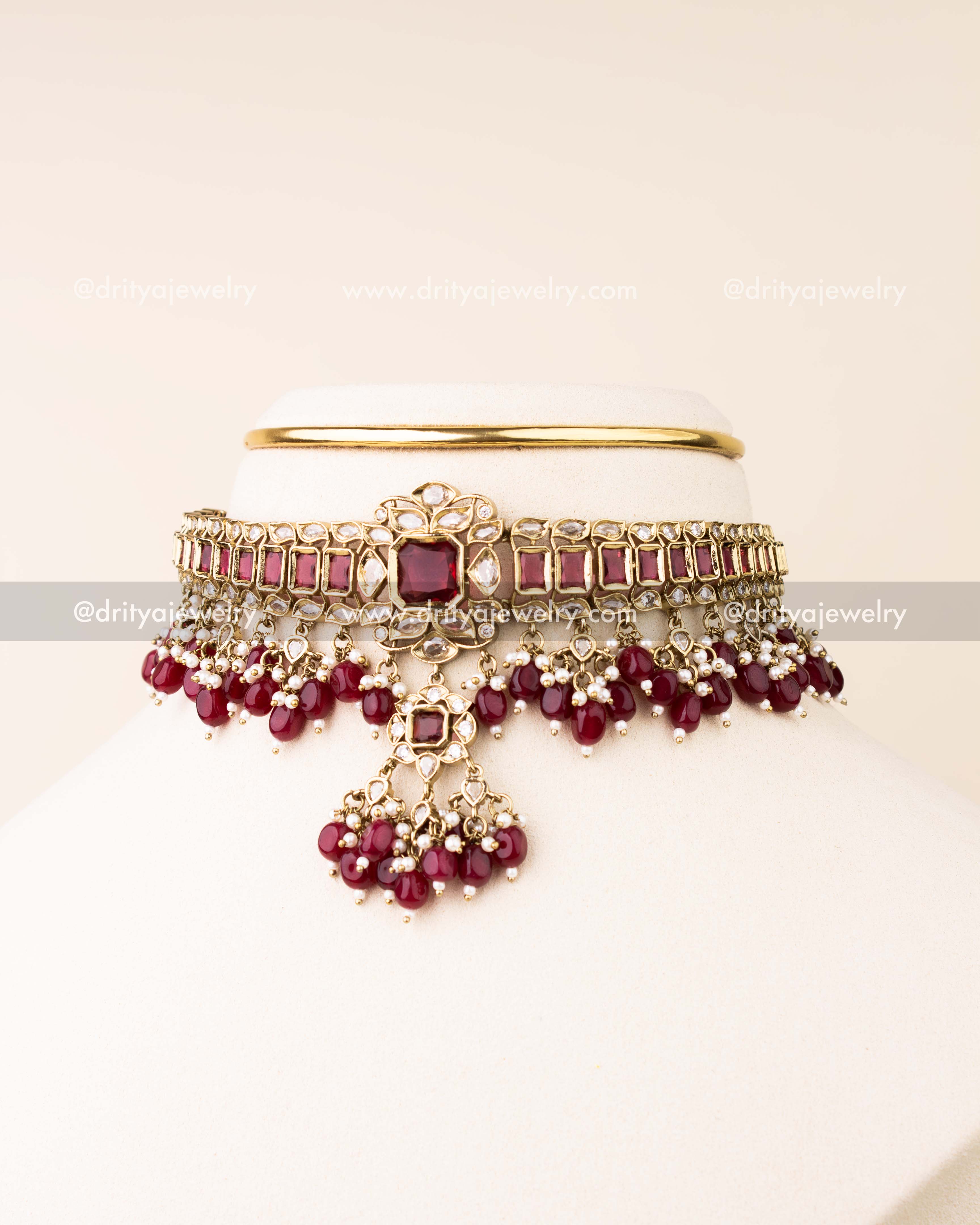 Premium choker necklace with ruby red stones, reverse AD detailing, and bead drops with matching earrings.