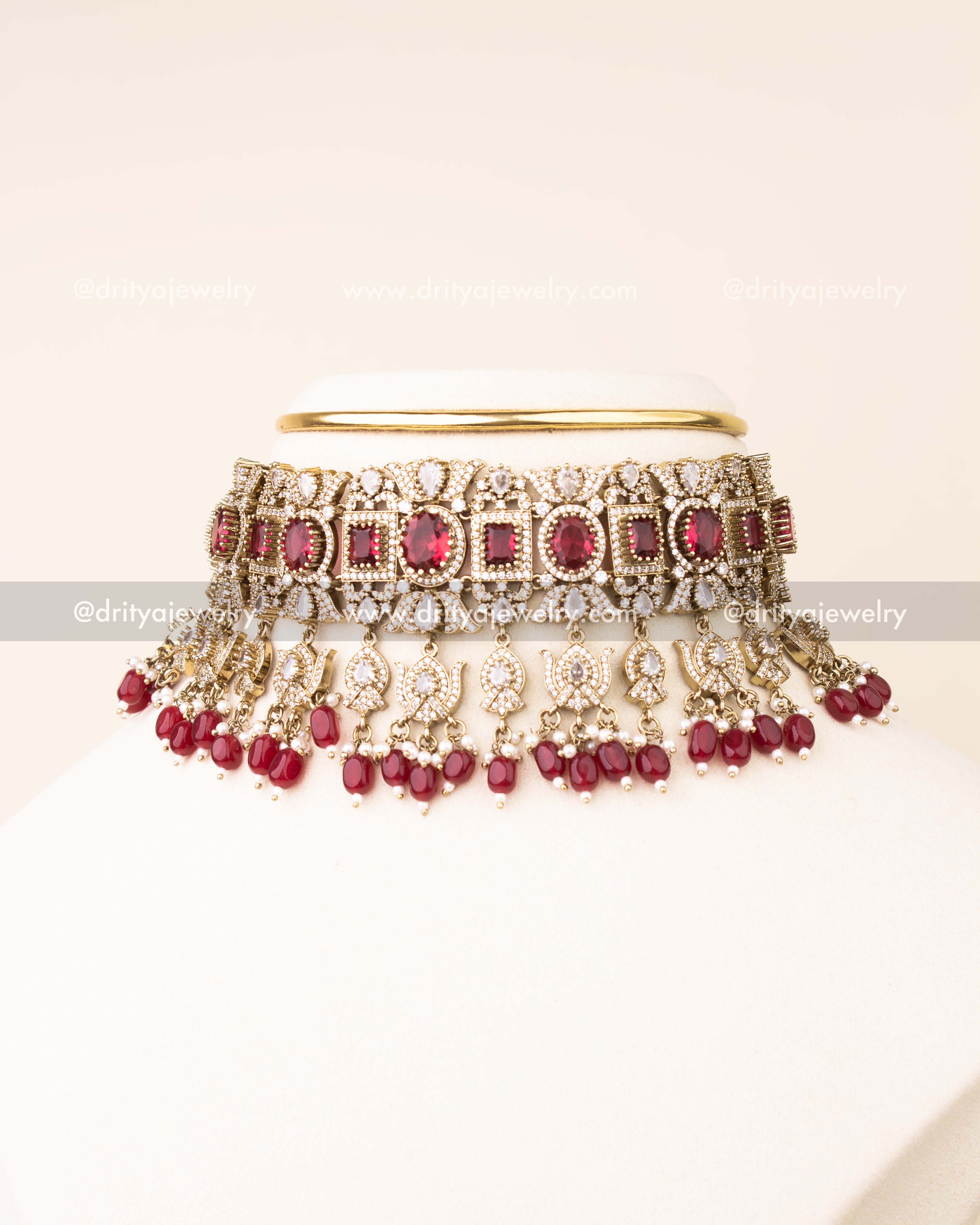 Luxurious ruby red bridal choker with AD stones and matching earrings.