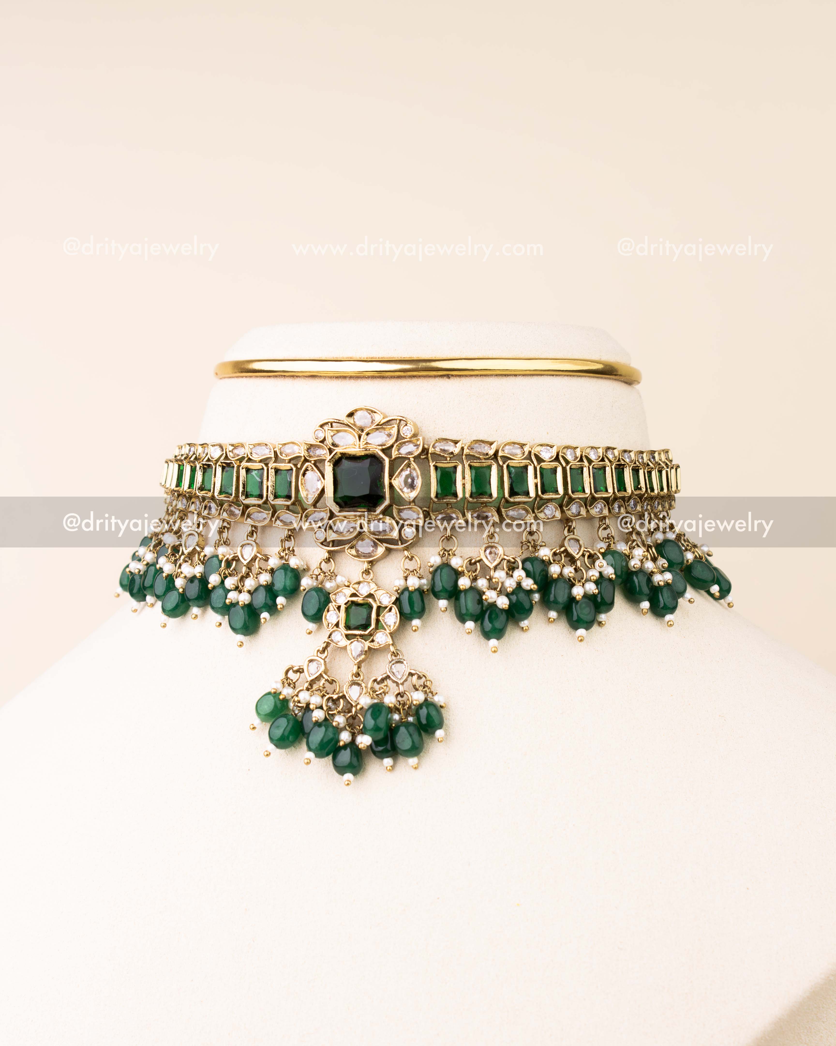 Premium choker necklace featuring green stones, reverse AD stones, and emerald bead drops with matching earrings.