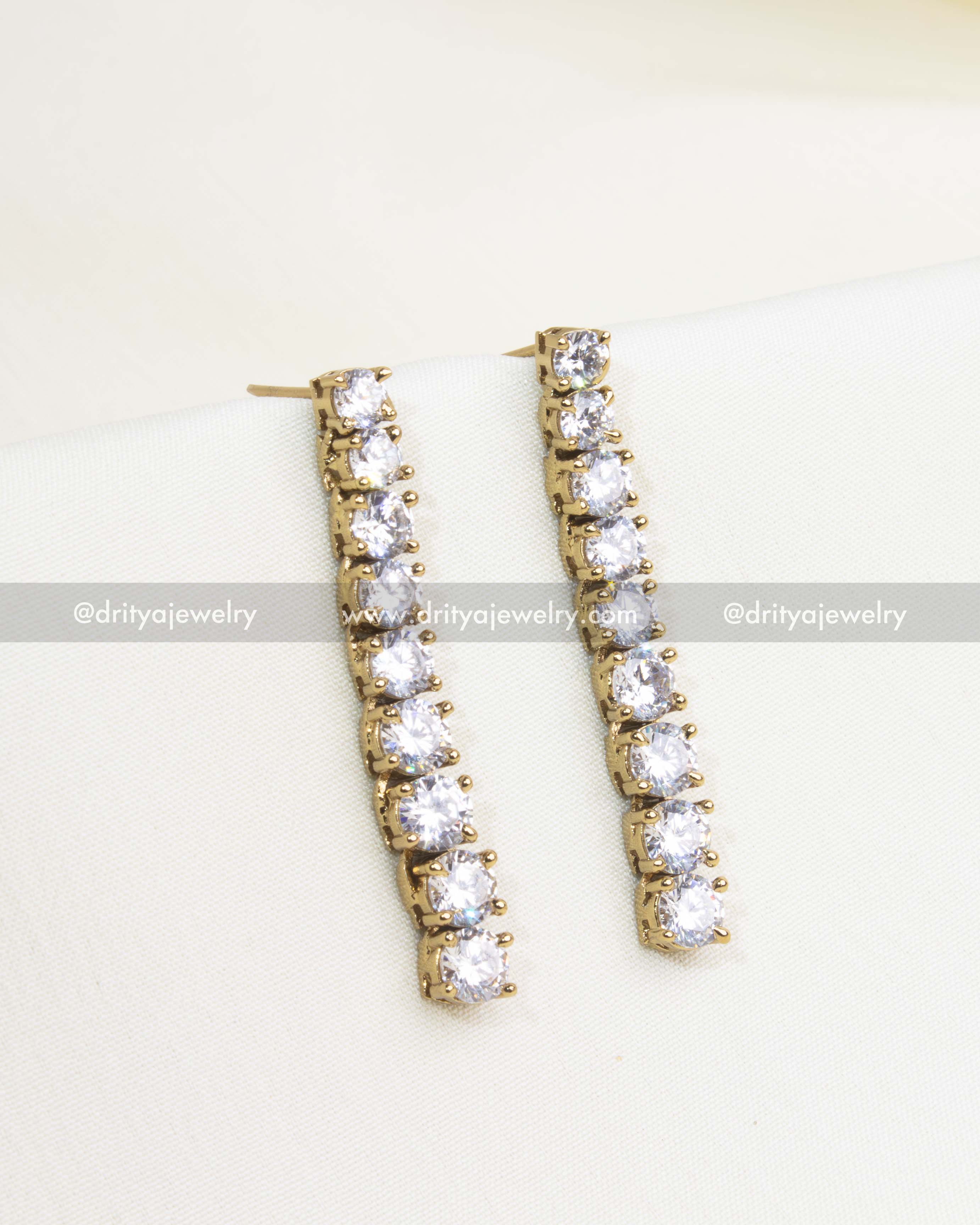 Gold-tone drop earrings with cubic zirconia stones.
