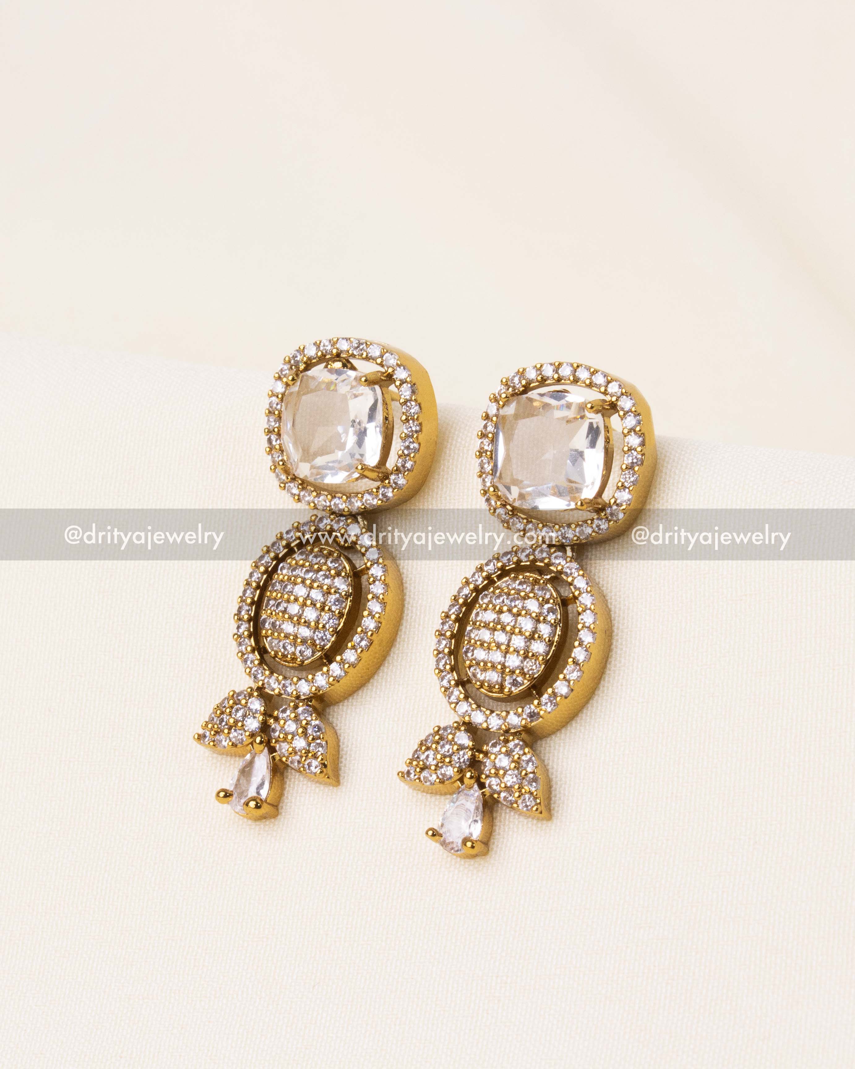 Exquisite drop earrings with CZ stones and floral motifs, crafted for a sophisticated look.