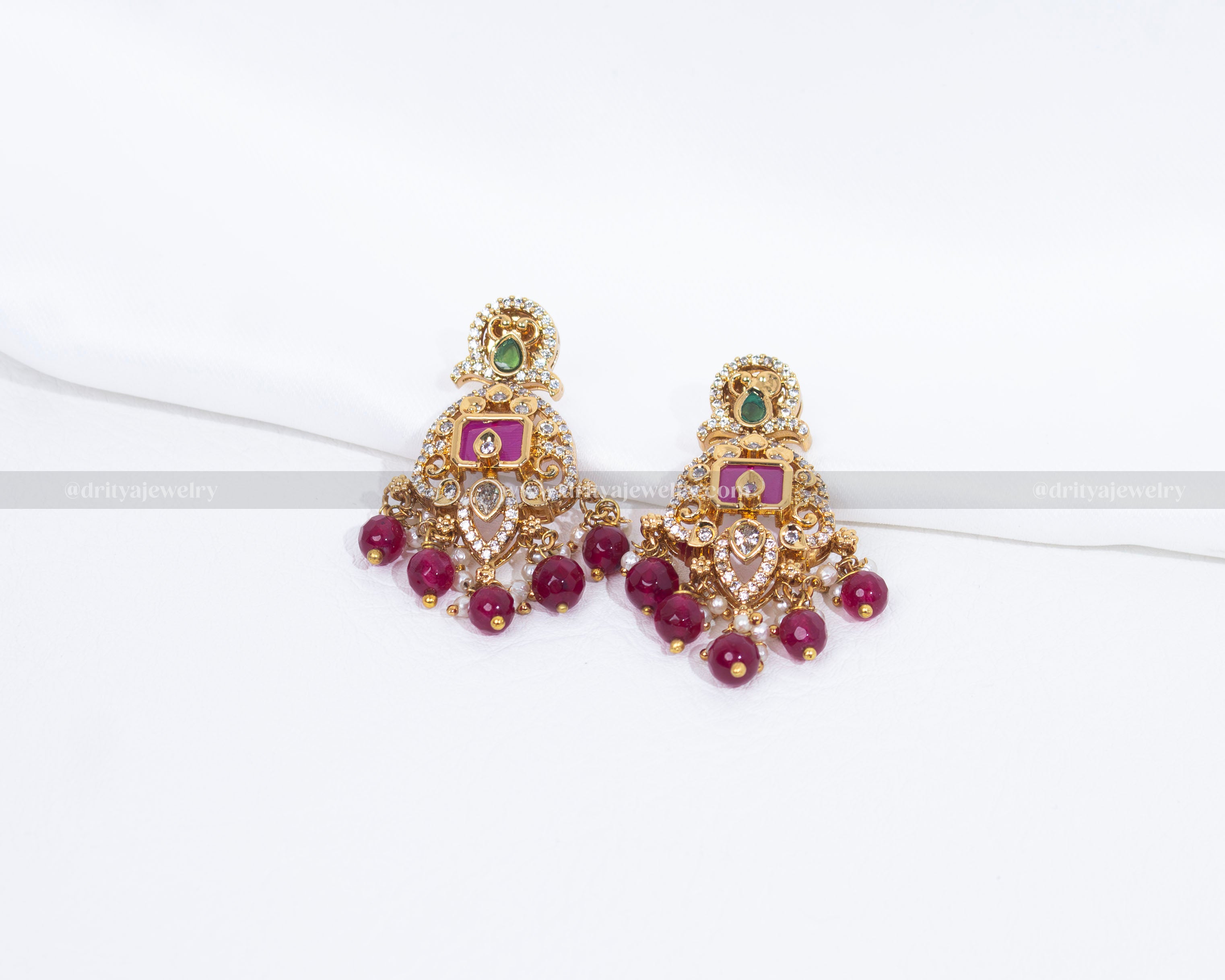 Pair of matching earrings from the Majestic Crown Style Necklace Set by Dritya Jewelry, adorned with green CZ stones and ruby drops.