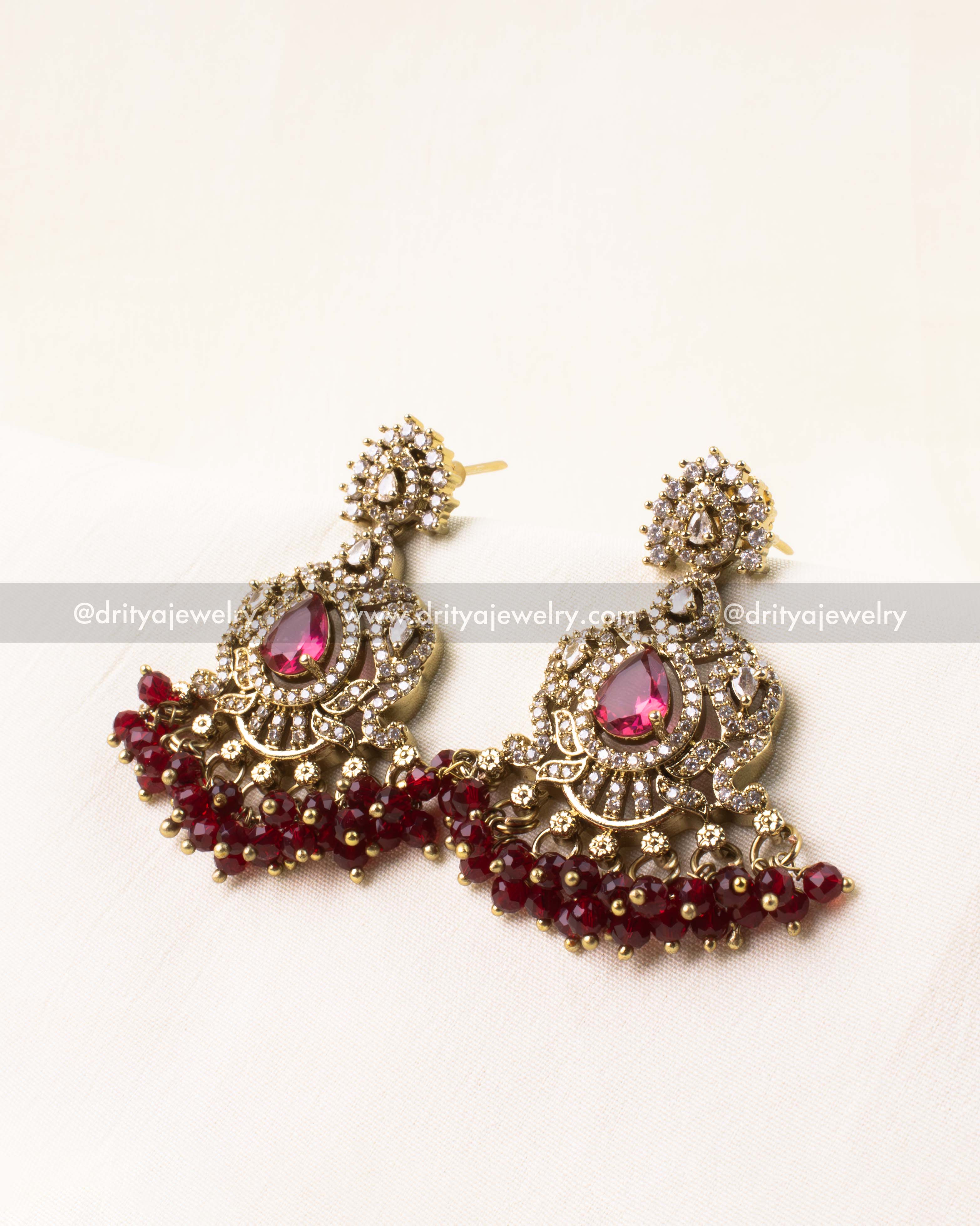 Victorian-style earrings with ruby-colored AD stones and bead hangings.