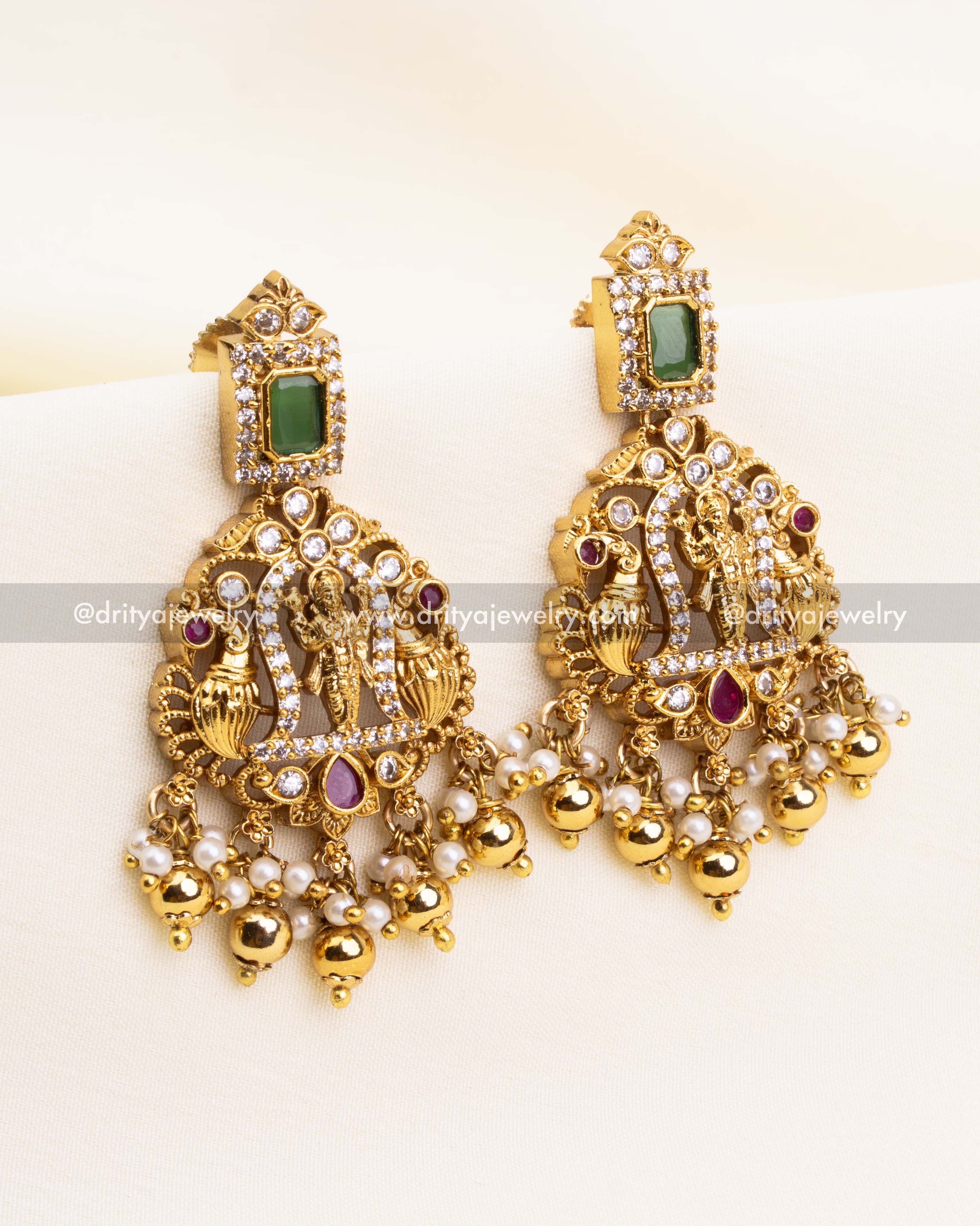 Gold-plated earrings with Narasimha deity and green rectangular tops, finished with ball and pearl drops.