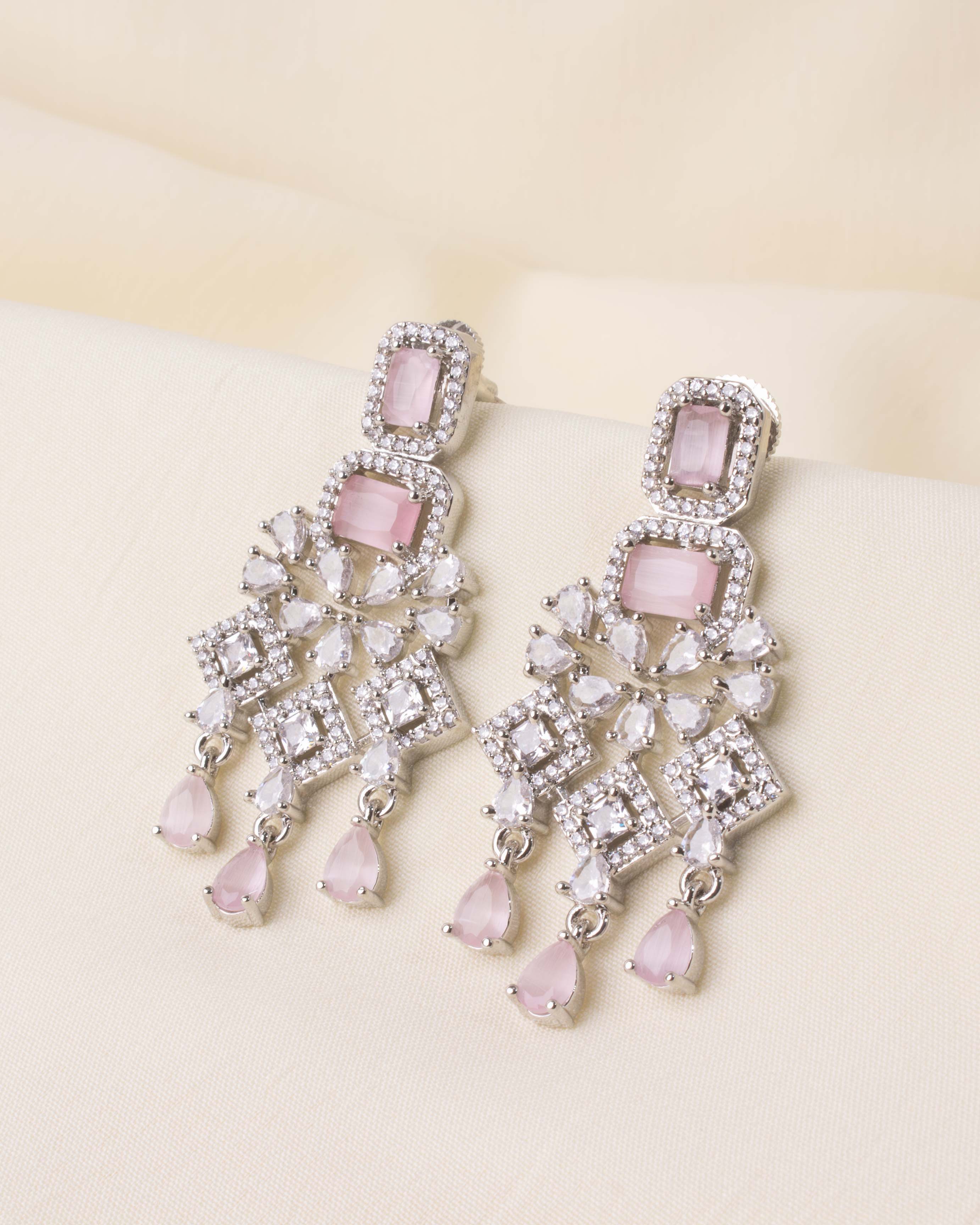 Dangling earrings with blush pink stones and CZ detailing, matching the necklace set.