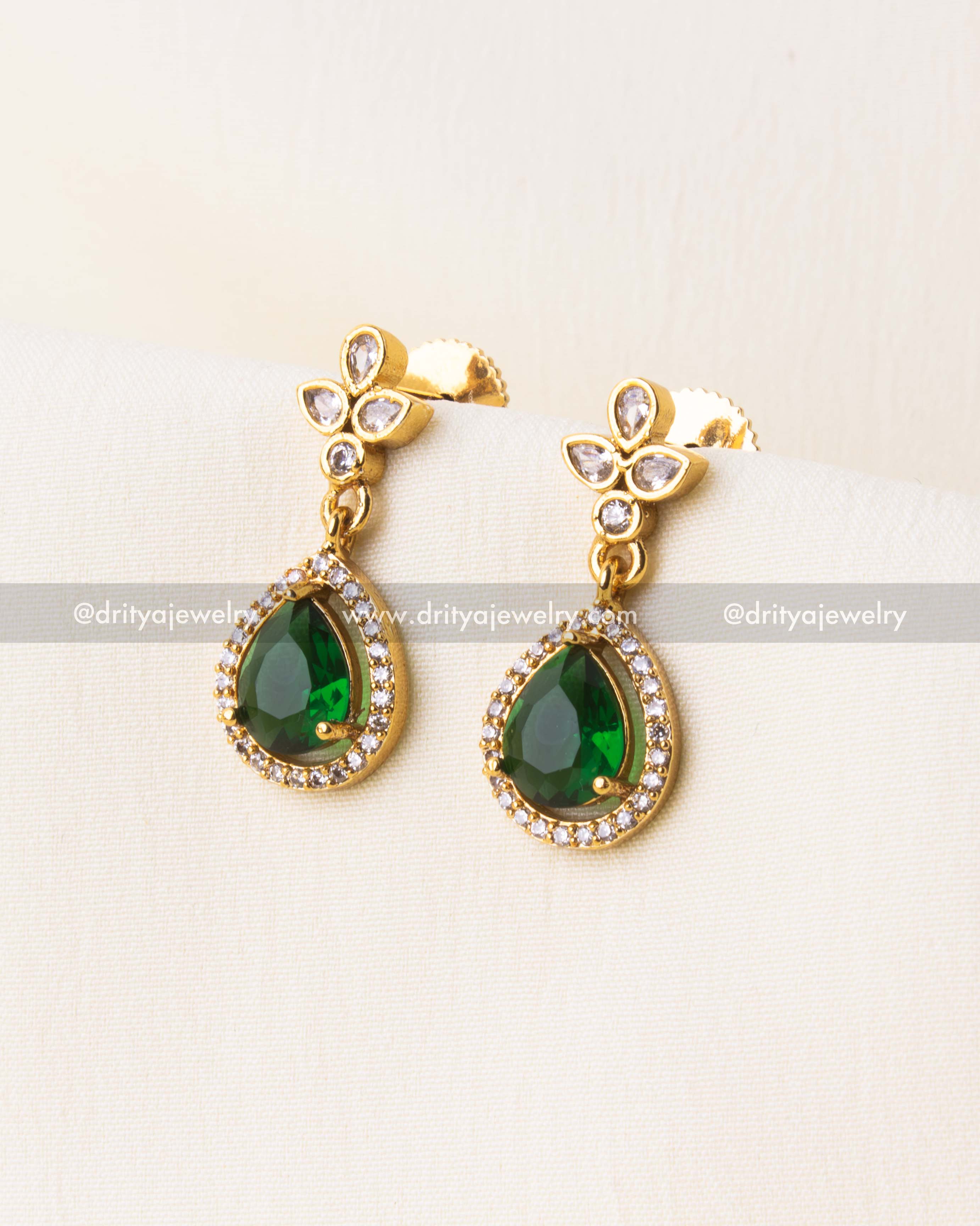 Gold-plated earrings with teardrop green stones and floral CZ tops.