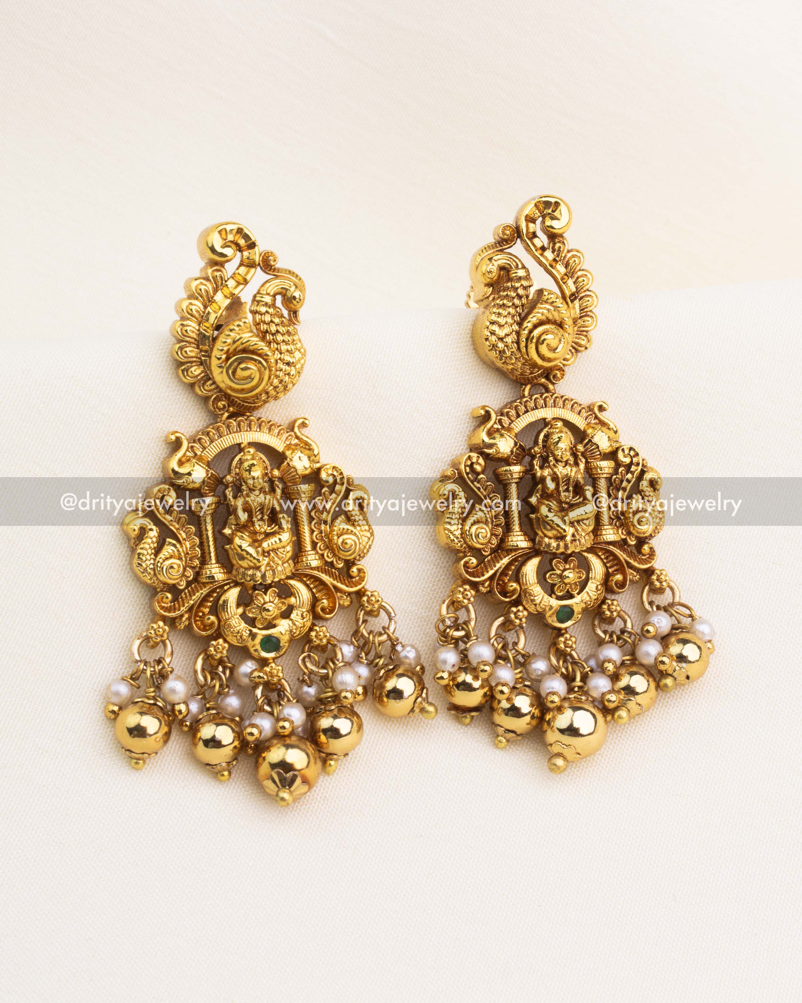 Temple-style Lakshmi earrings with peacock top, pearls, and gold ball drops.