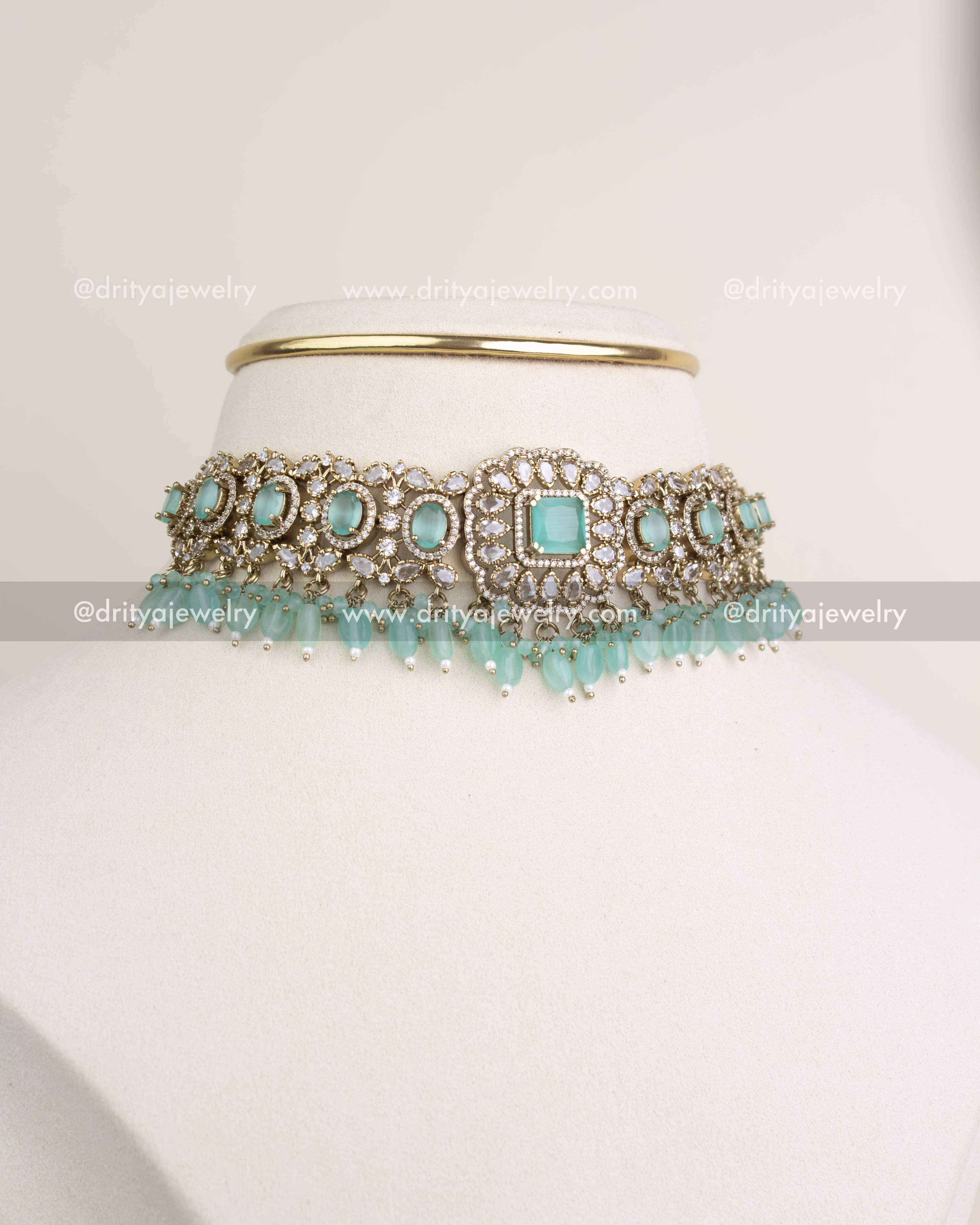 Victorian mint choker with CZ stones and droplet beads displayed on a jewellery stand.