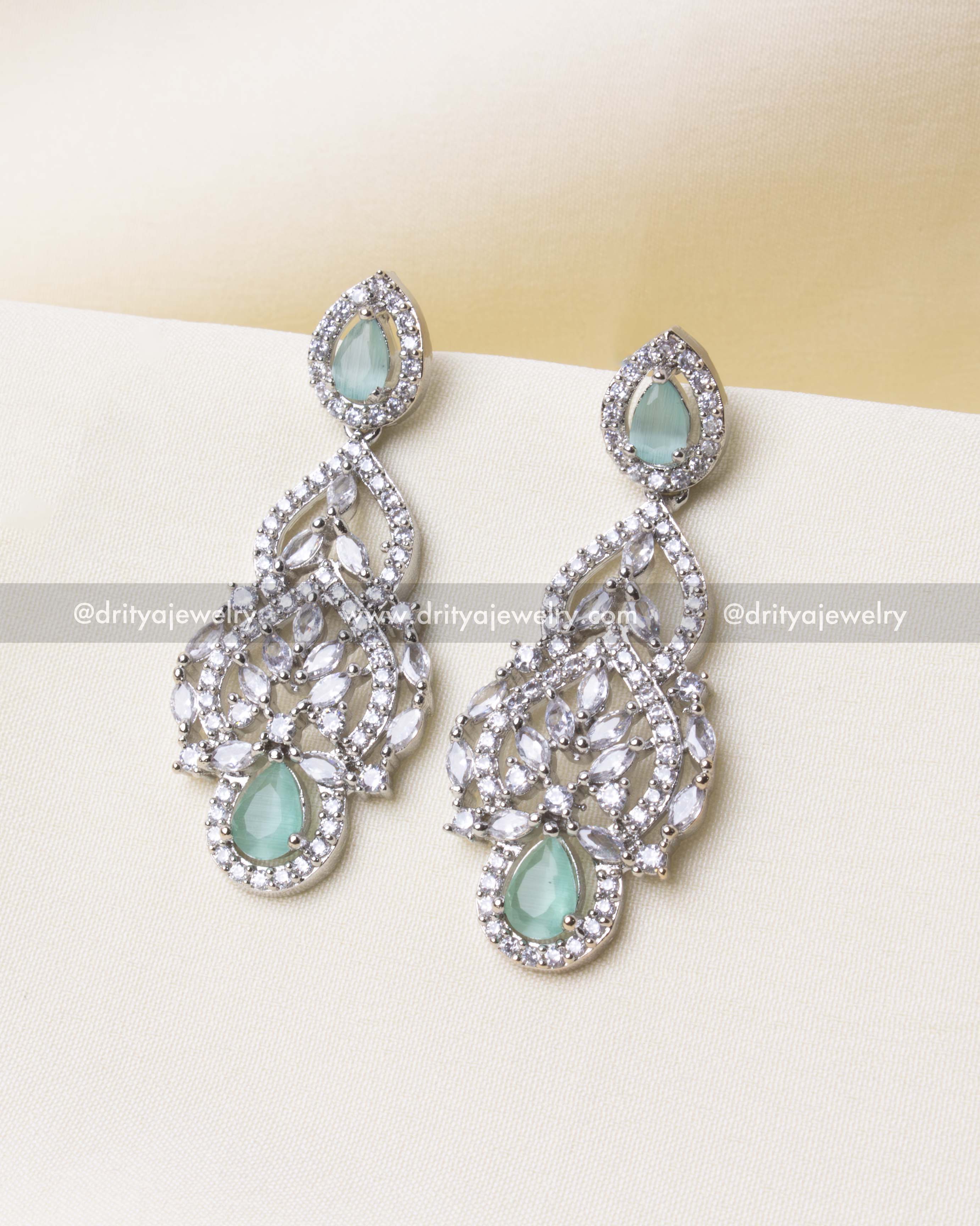 Mint Zircon Earrings Close-Up" Alt Text: "Drop-style earrings with mint-colored zircon stones and cubic zirconia accents.