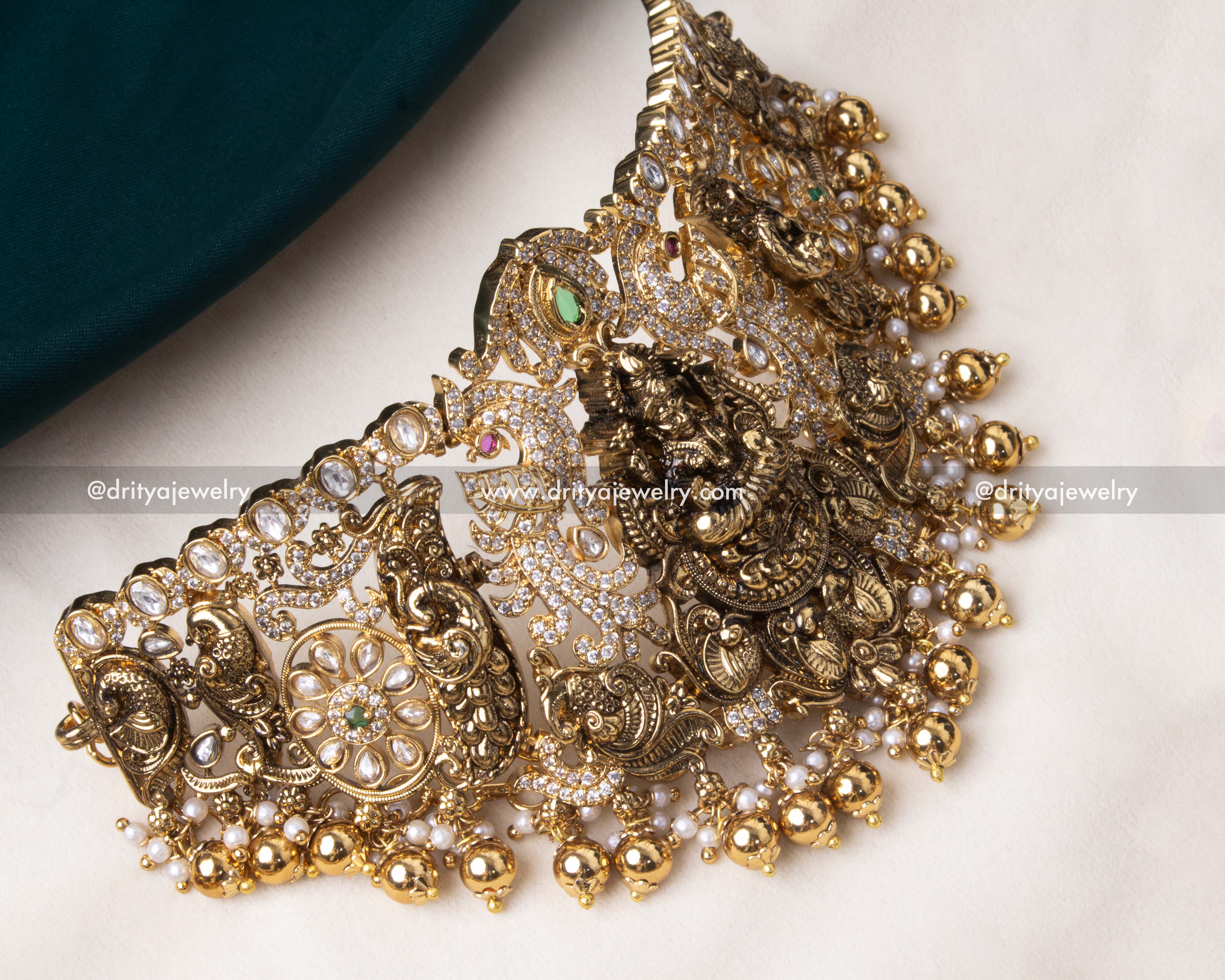 Close-up of Nakshi choker with peacock motifs, sparkling gemstones, and pearls.