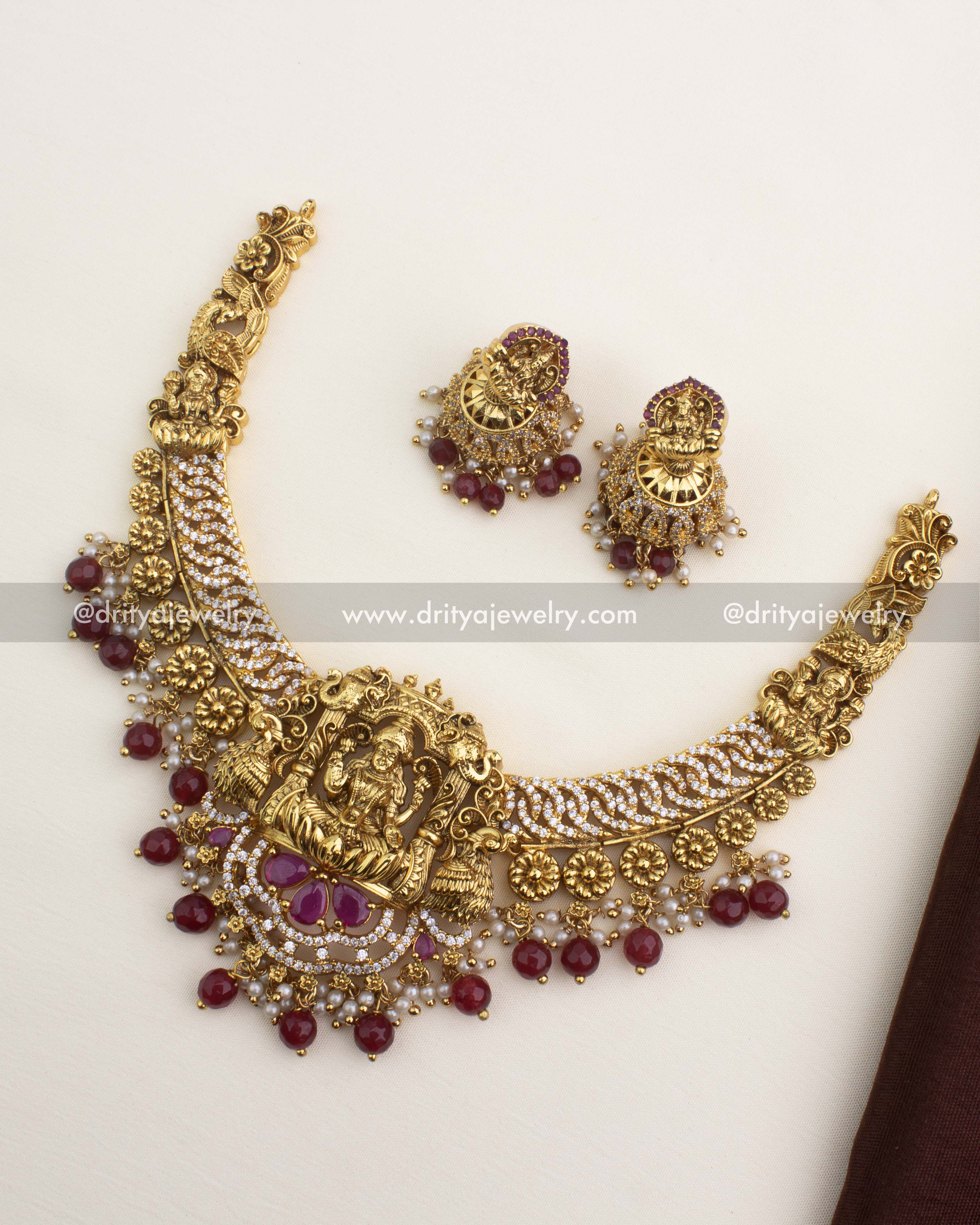 Premium nakshi temple necklace with Lakshmi pendant, CZ jalebi work, and ruby red stone hangings.